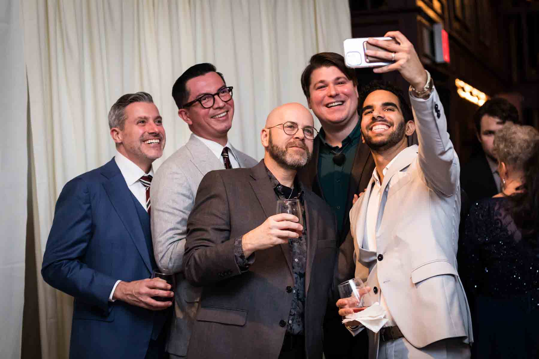 Group of guests taking a selfie at a wedding reception for an article on how to take the perfect selfie