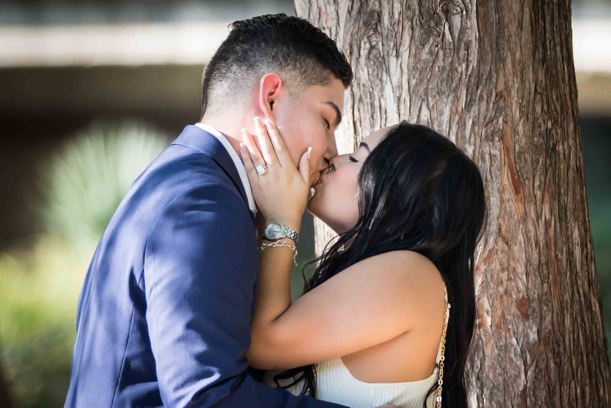 Couple kissing on little island at Pearl Springs after proposal for an article on Pearl surprise proposal tips