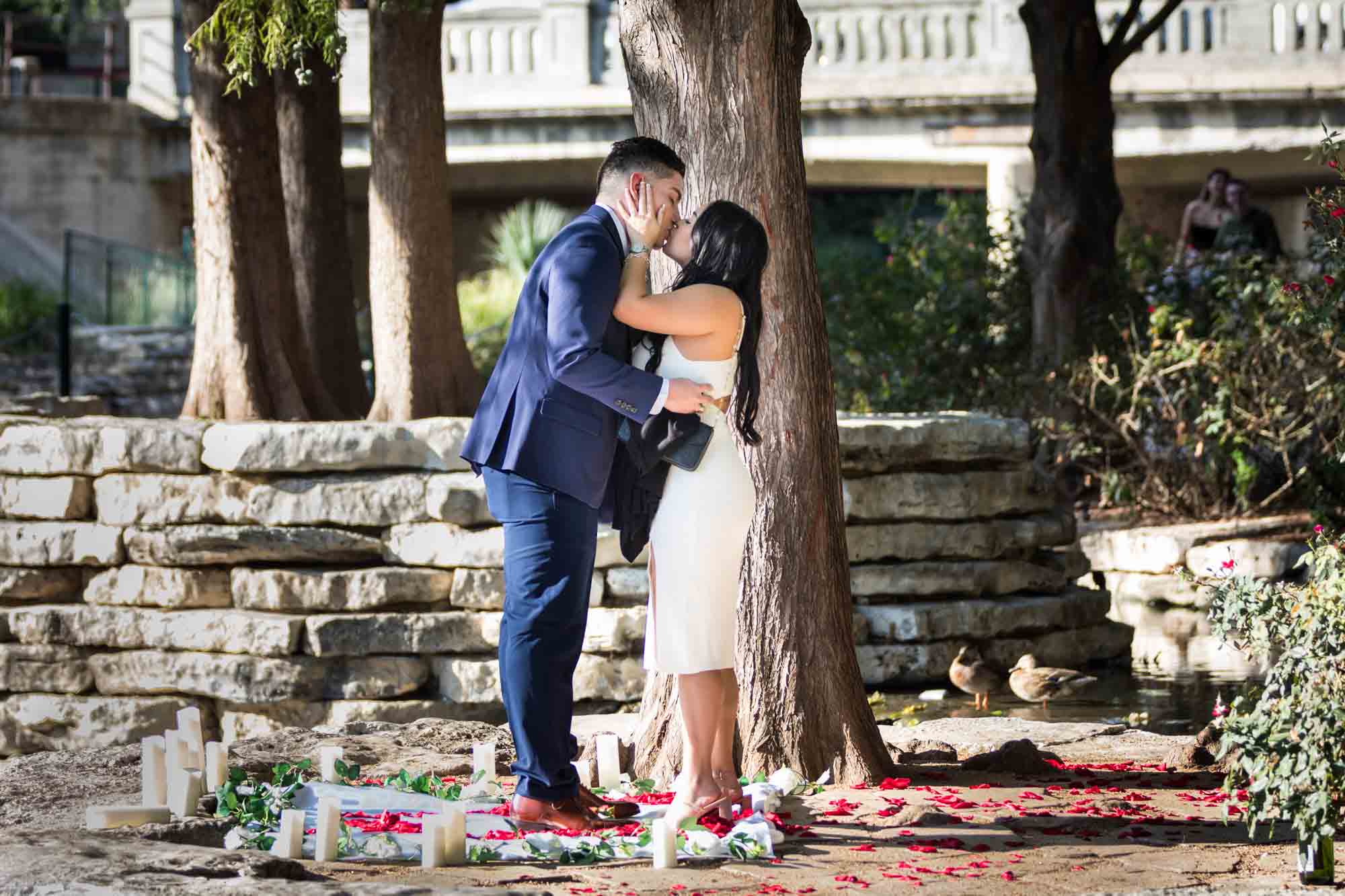 Couple kissing on little island at Pearl Springs after proposal for an article on Pearl surprise proposal tips