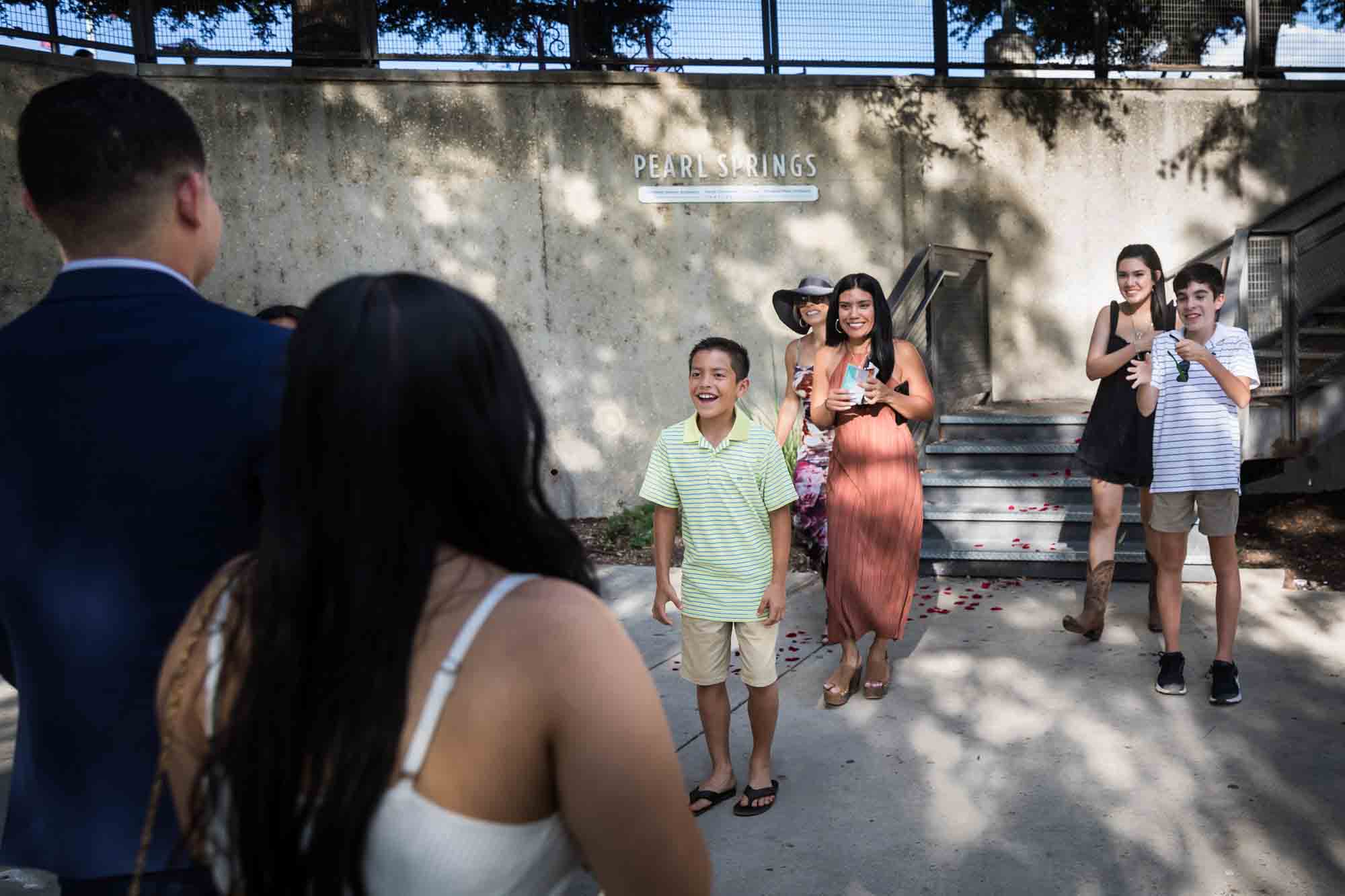 Family rushing towards couple after proposal for an article on Pearl surprise proposal tips