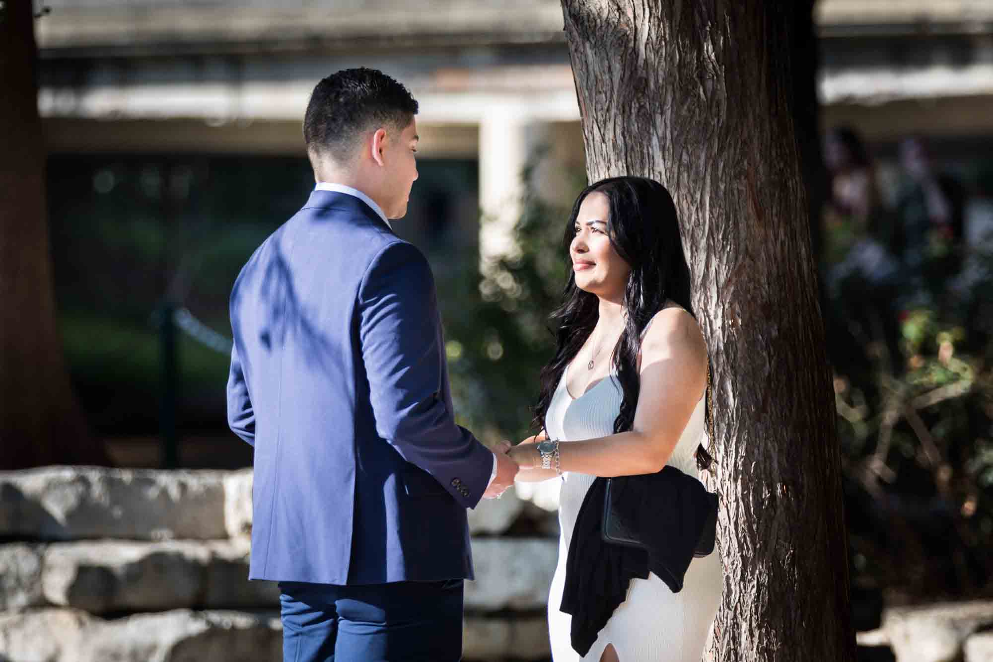 Man in blue suit proposing to woman at Pearl Springs after proposal for an article on Pearl surprise proposal tips