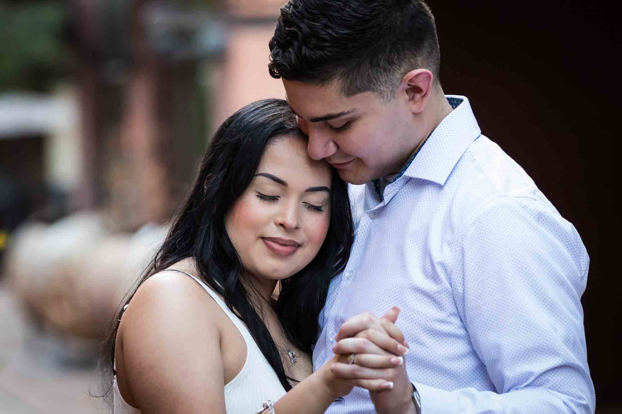 Couple dancing close with yellow flowers for an article on Pearl surprise proposal tips