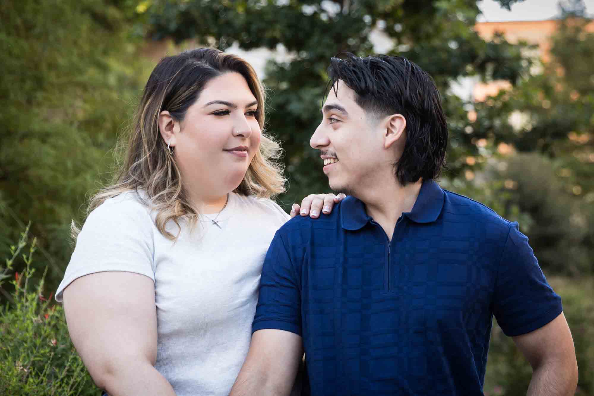 Couple holding hands on San Pedro Creek pathway during a downtown San Antonio photo shoot