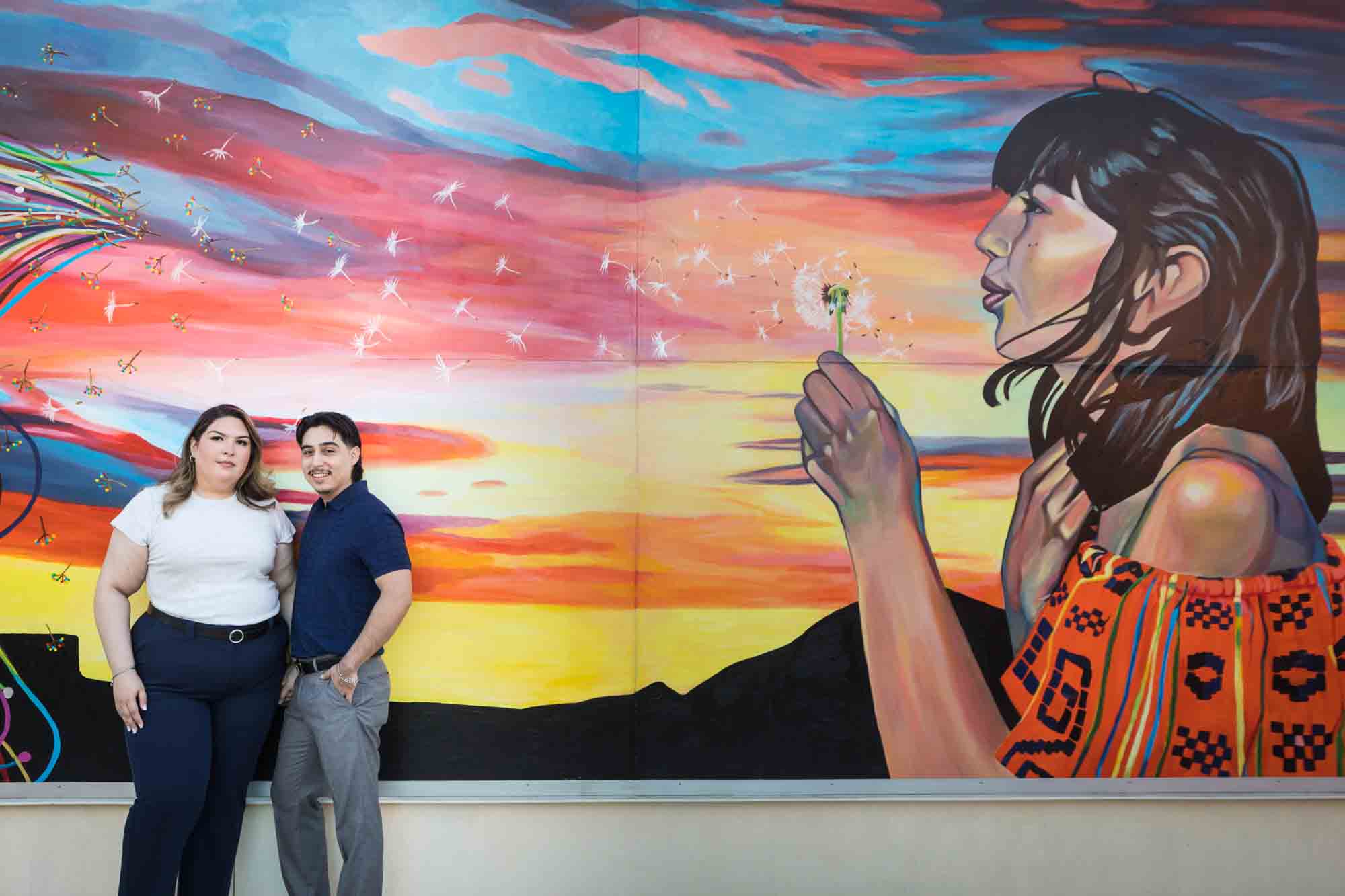 Couple standing in front of colorful mural during a downtown San Antonio photo shoot