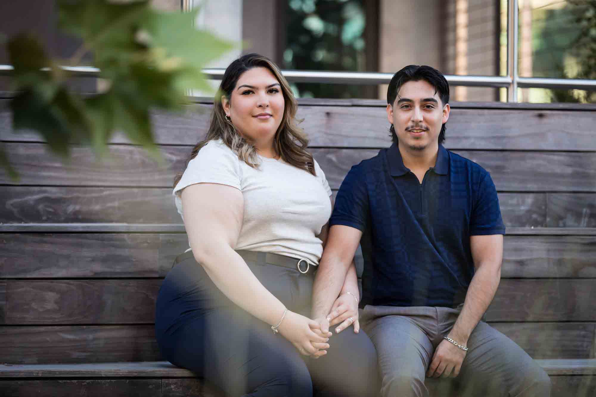 Couple sitting on wooden steps during a downtown San Antonio photo shoot