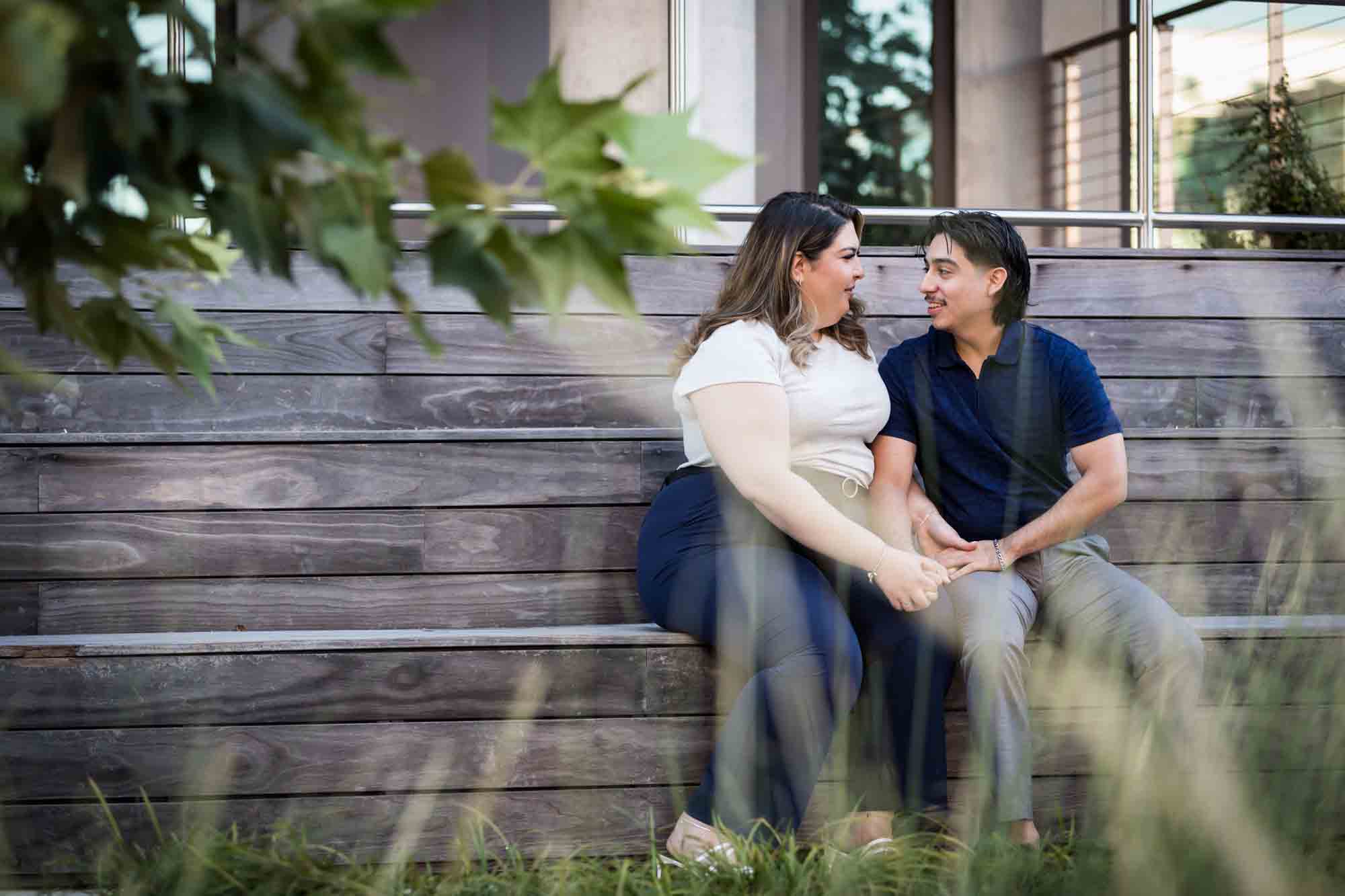 Couple sitting on wooden steps during a downtown San Antonio photo shoot