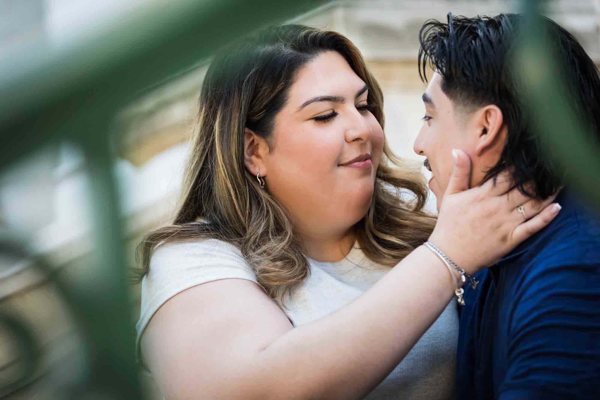 Couple sitting on back staircase of City Hall during a downtown San Antonio photo shoot