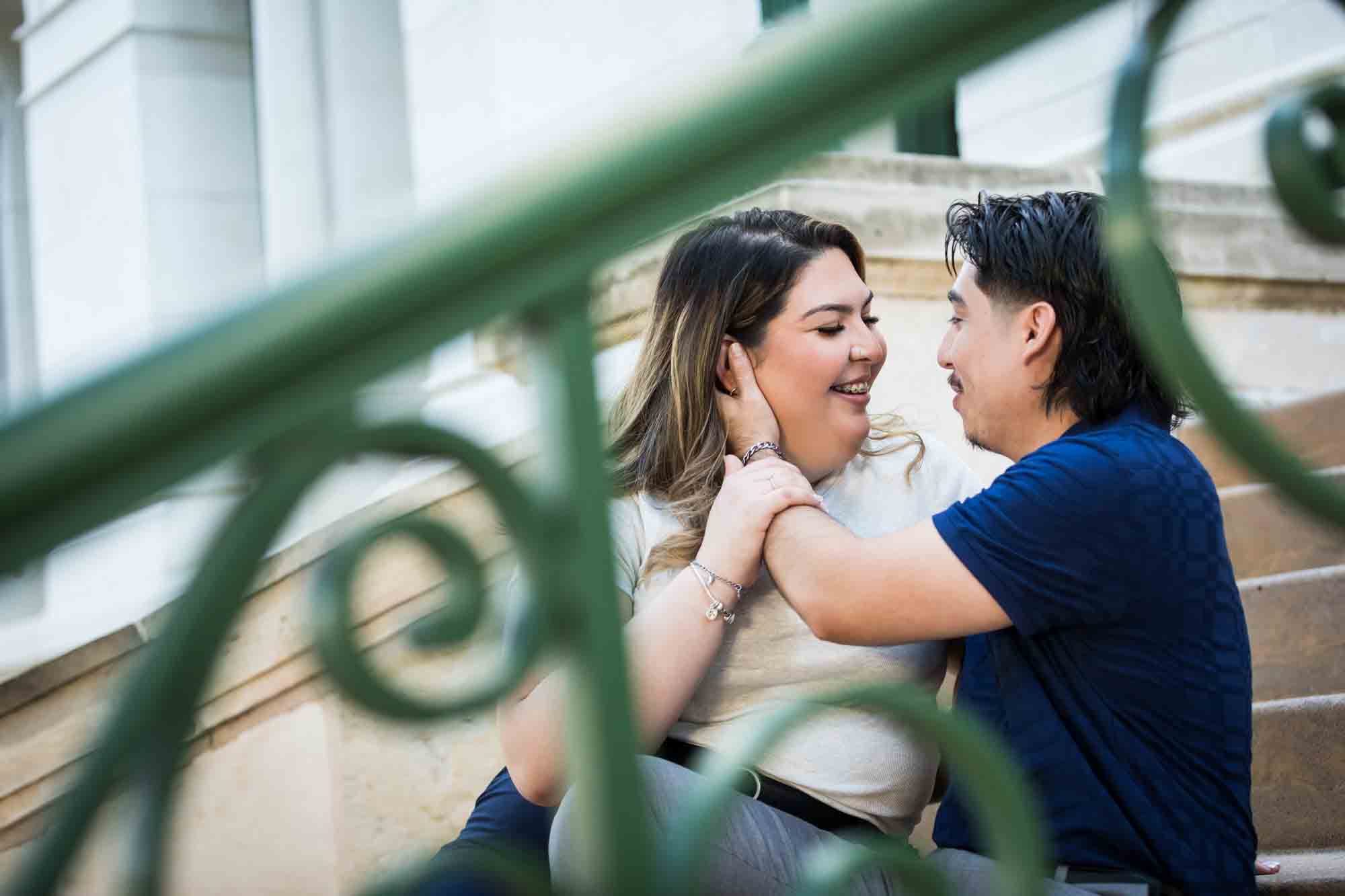 Couple sitting on back staircase of City Hall during a downtown San Antonio photo shoot