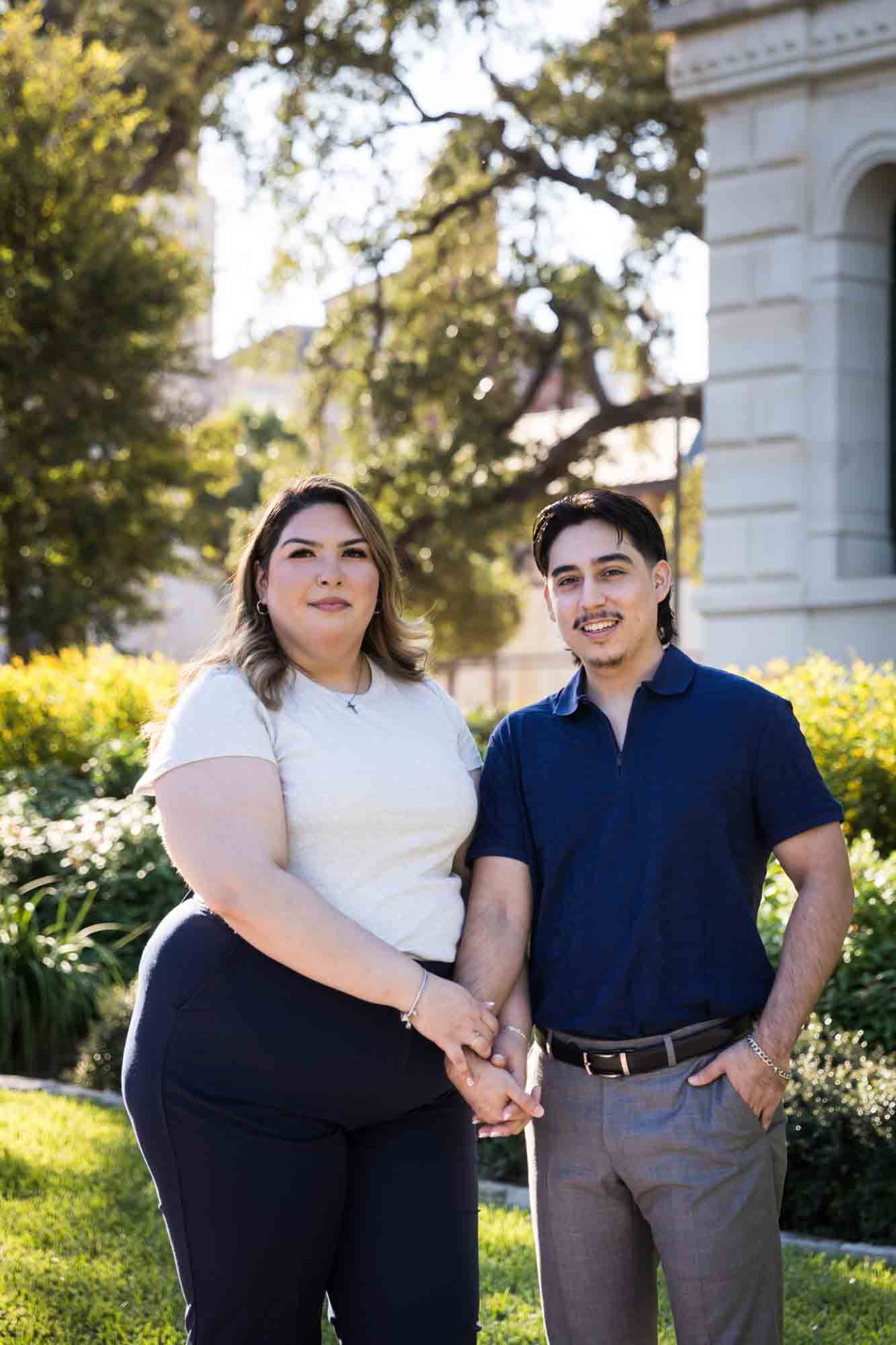 Couple standing to the side of City Hall during a downtown San Antonio photo shoot