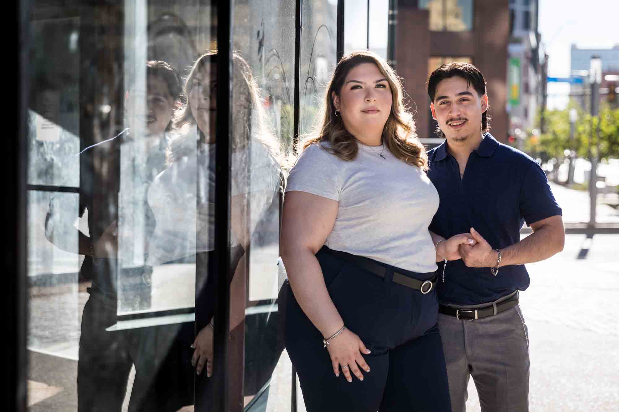 Couple standing in front of reflective windows during a San Antonio photo shoot