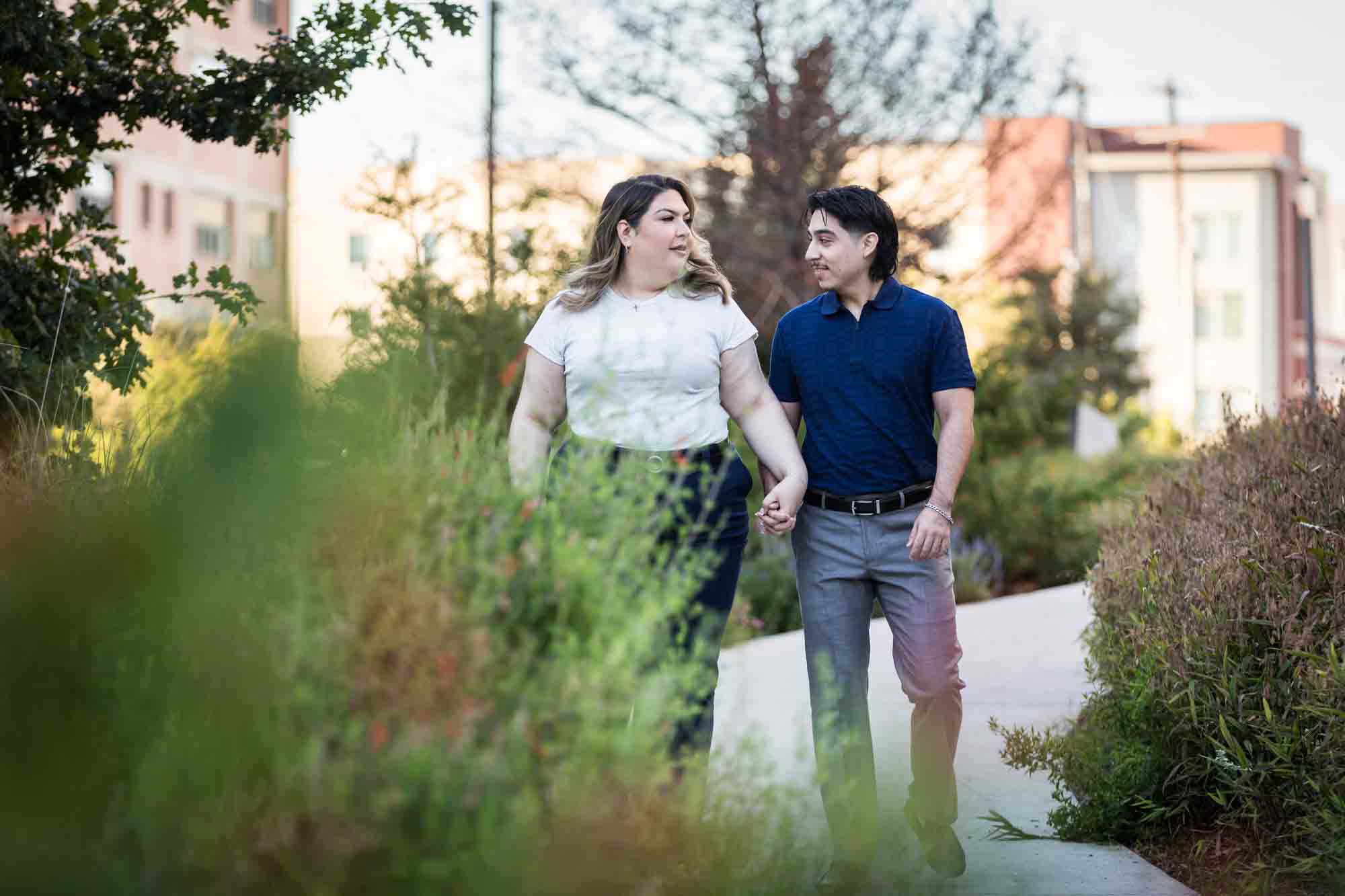 Couple walking along San Pedro Creek pathway during a downtown San Antonio photo shoot