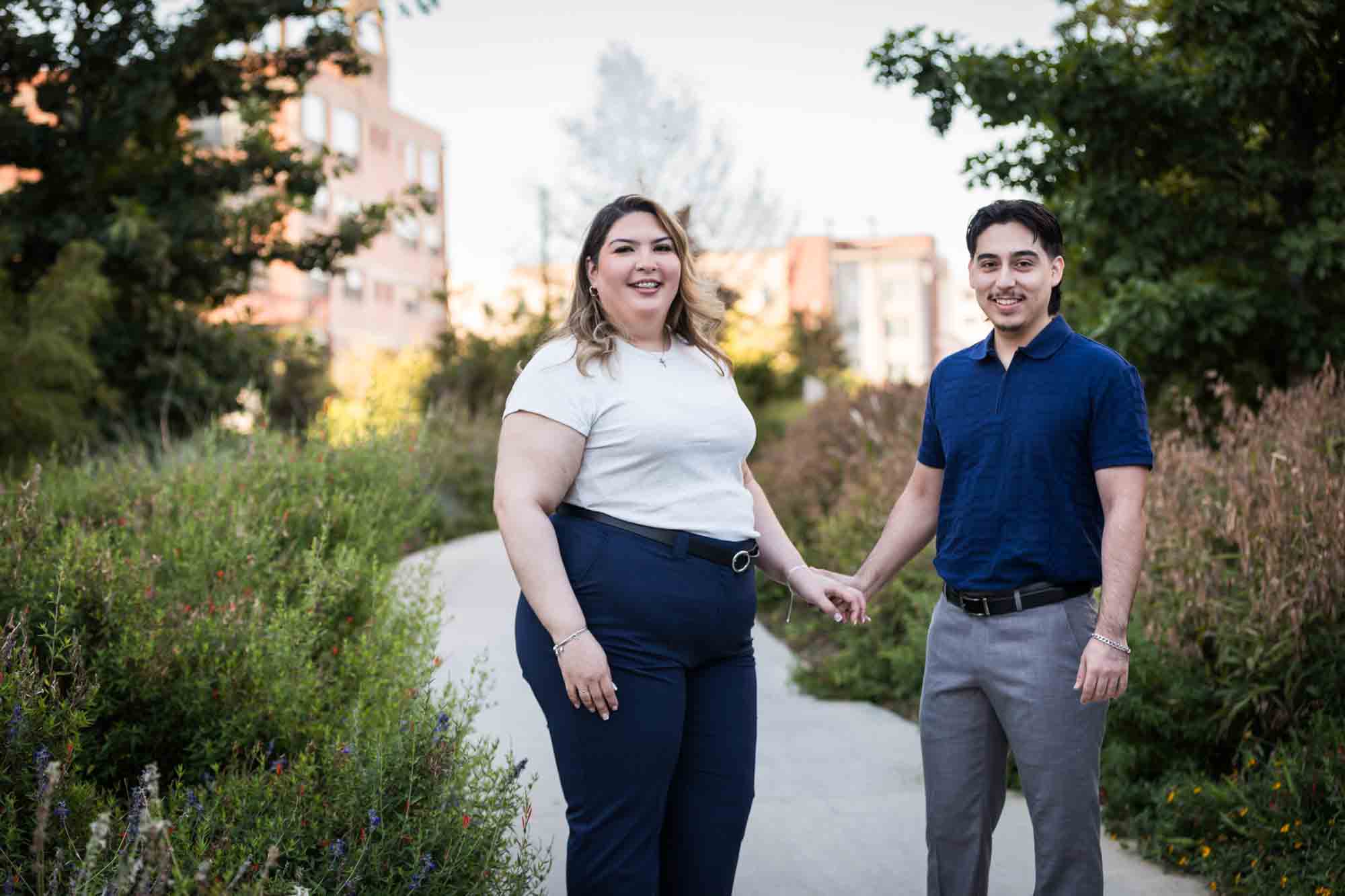 Couple holding hands on San Pedro Creek pathway during a downtown San Antonio photo shoot