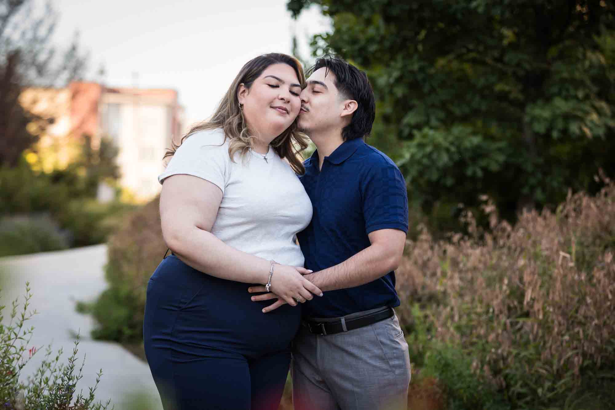 Couple kissing on San Pedro Creek pathway during a downtown San Antonio photo shoot