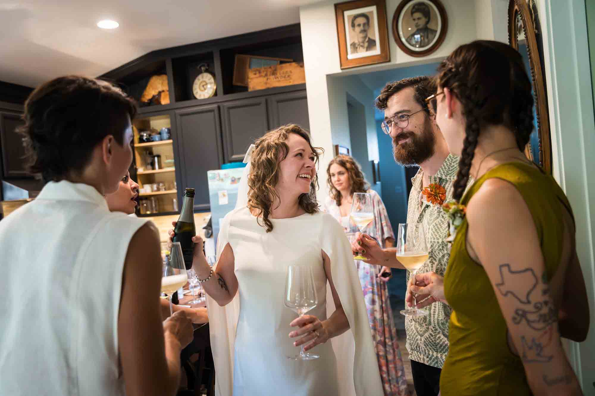 Guests drinking wine and enjoying reception at a Boerne backyard wedding