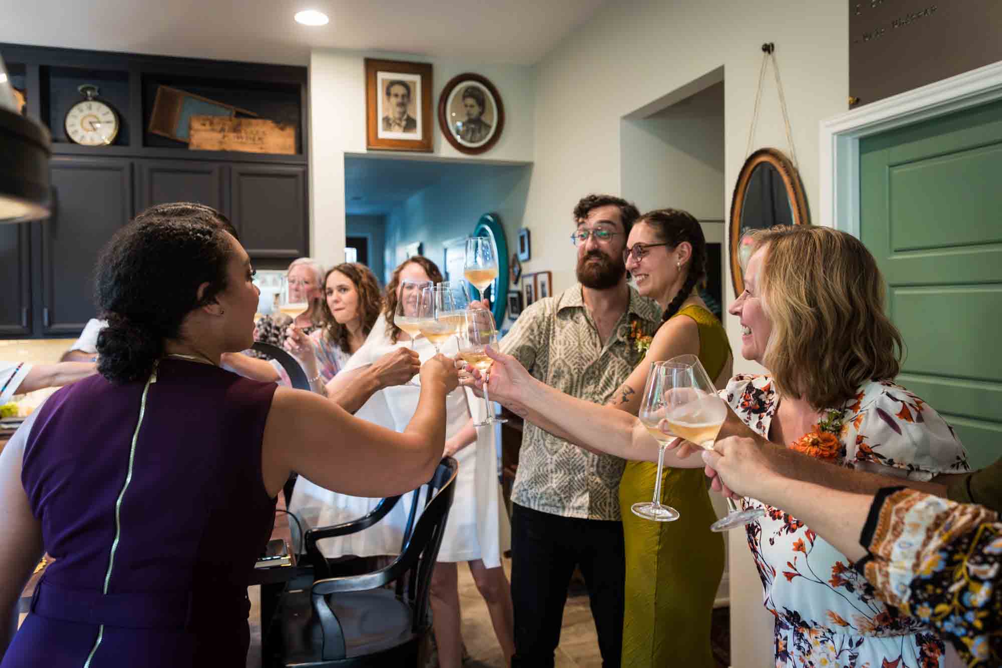 Guests clinking glasses in a cheer at a Boerne backyard wedding