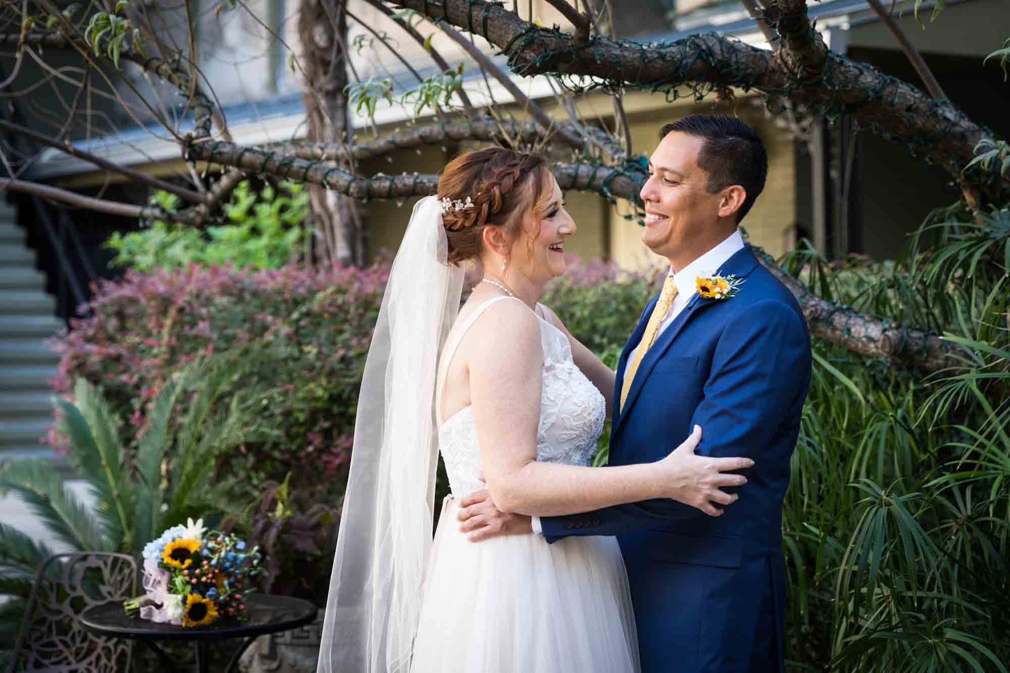 Bride and groom dancing in plant-filled courtyard at the Menger Hotel