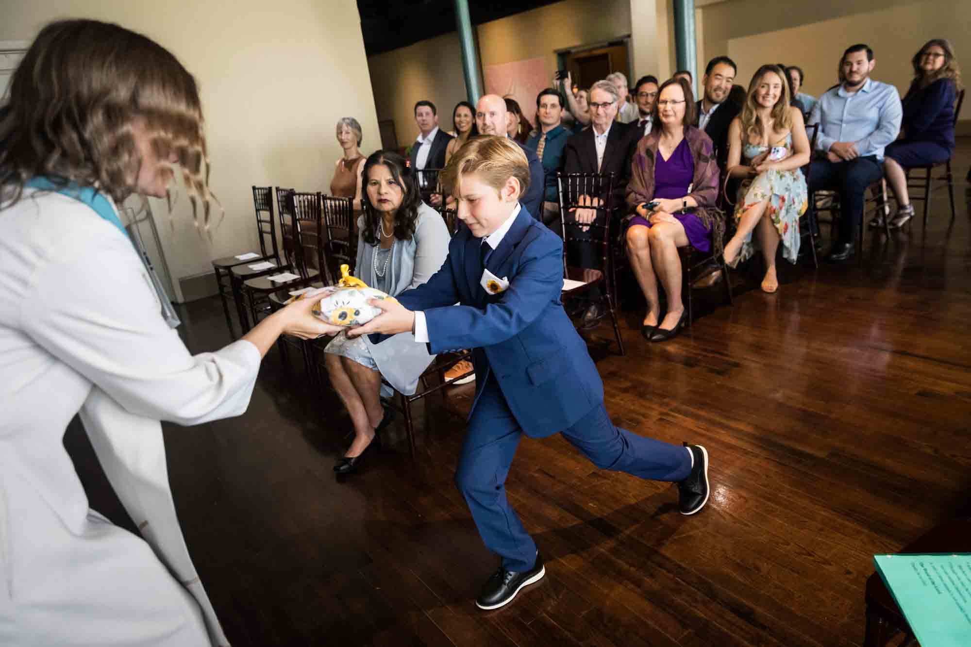 Pat O’Brien wedding photos of a ring bearer delivering pillow with ring to pastor