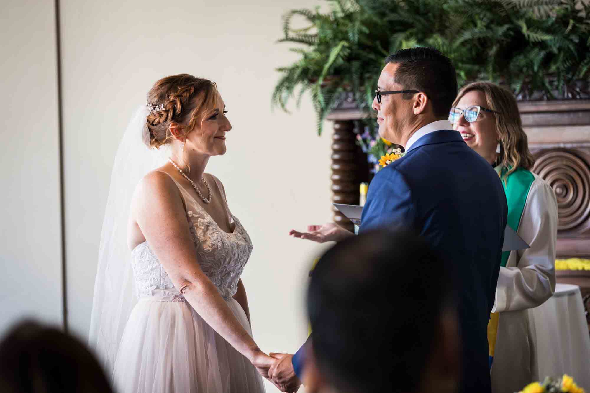 Pat O’Brien wedding photos of bride and groom exchanging vows during ceremony