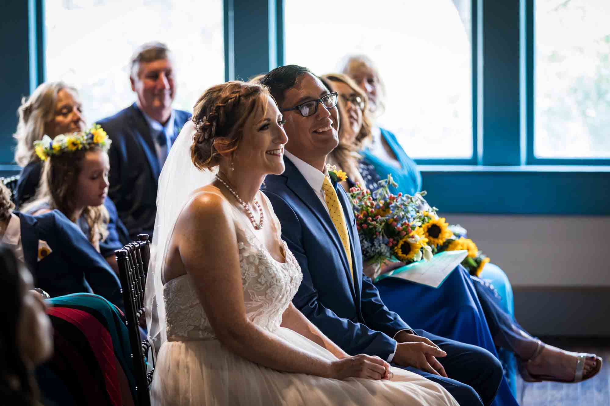 Pat O’Brien wedding photos of bride, groom and guests seated during ceremony