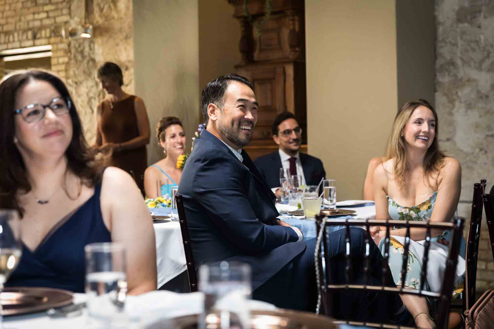 Pat O’Brien wedding photos of guests laughing during speeches while seated at tables