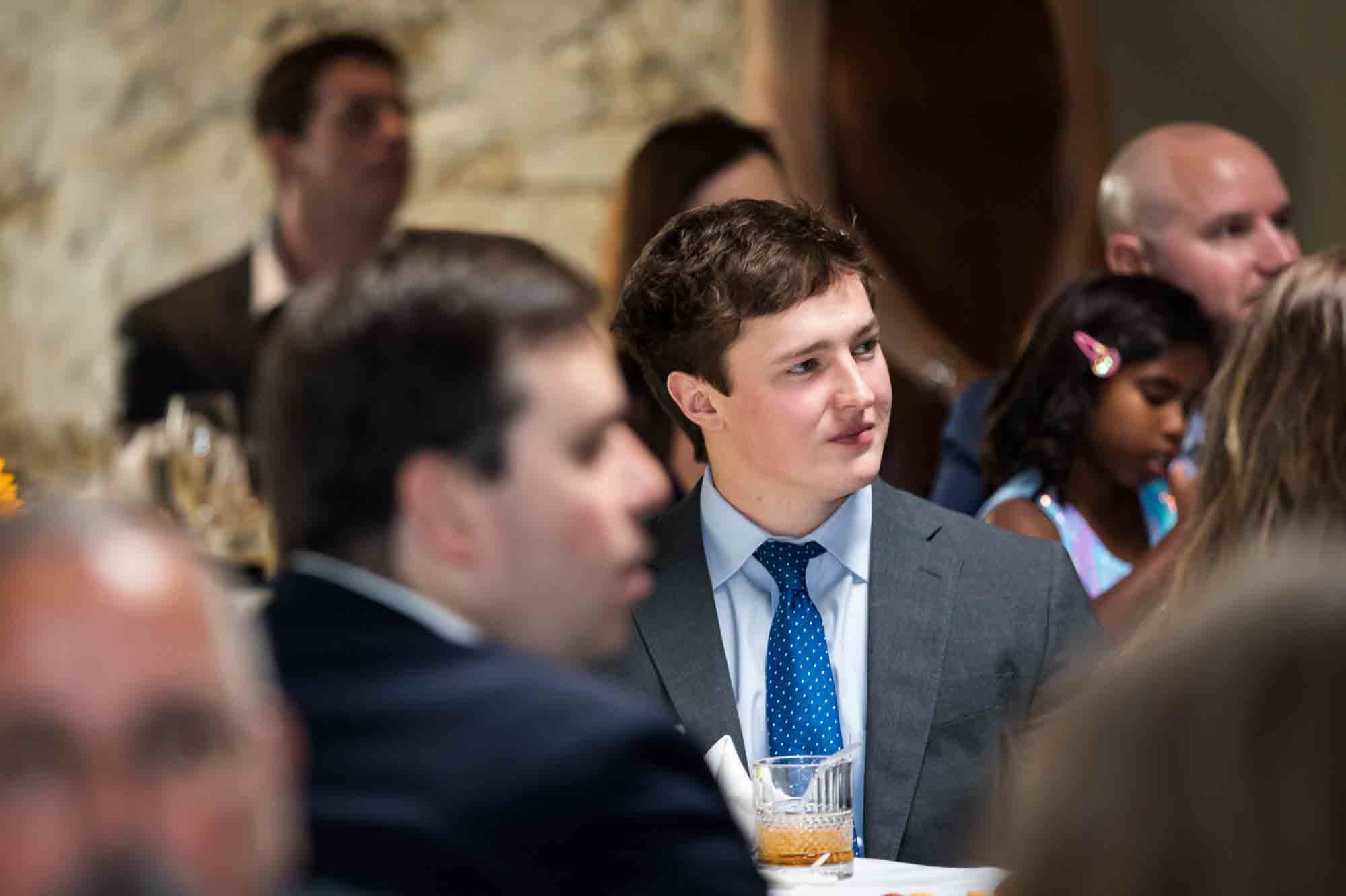 Pat O’Brien wedding photos of male guest wearing blue tie seated at table listening to speeches