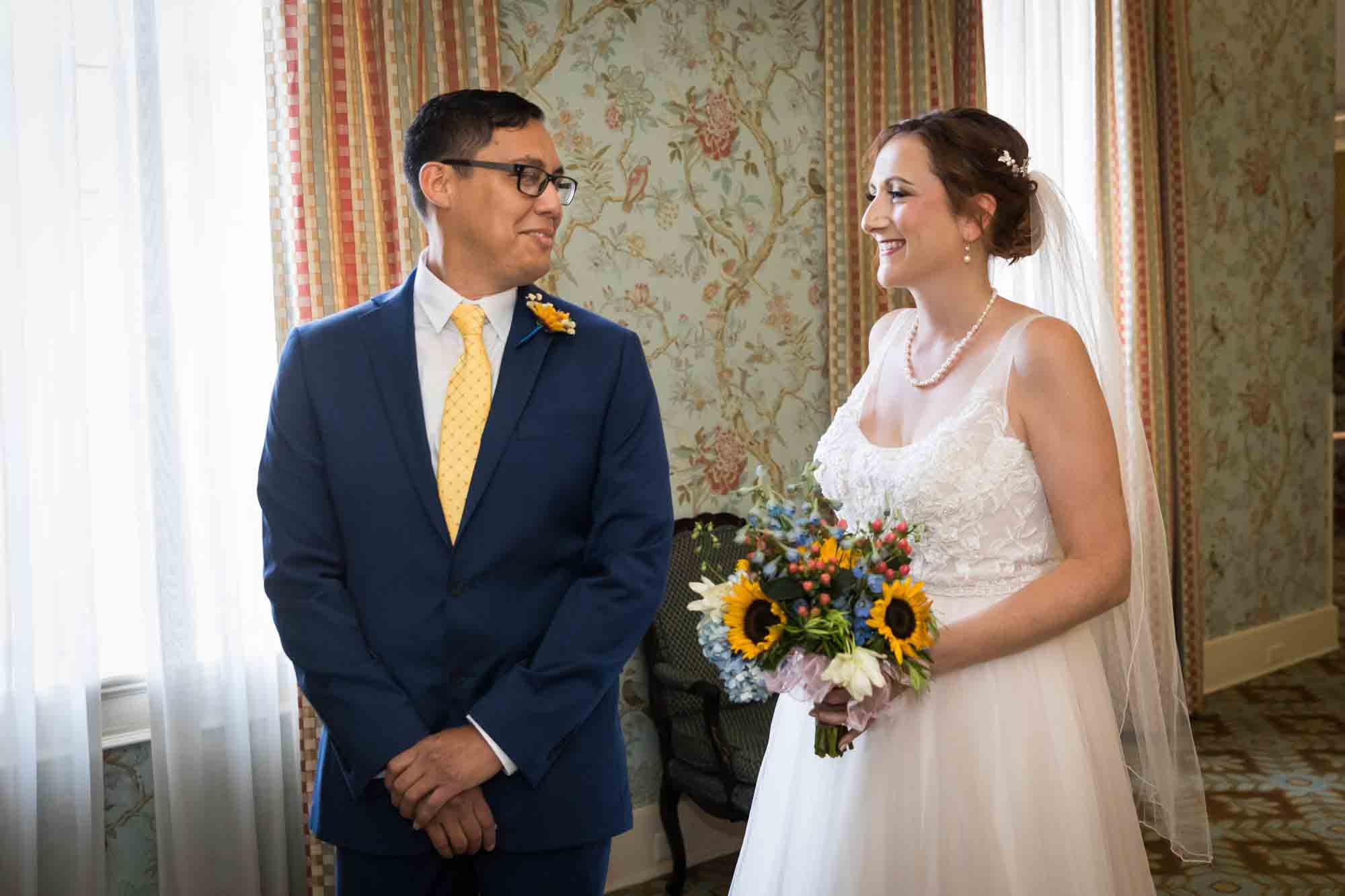 Groom looking back at bride during first look at the Menger Hotel