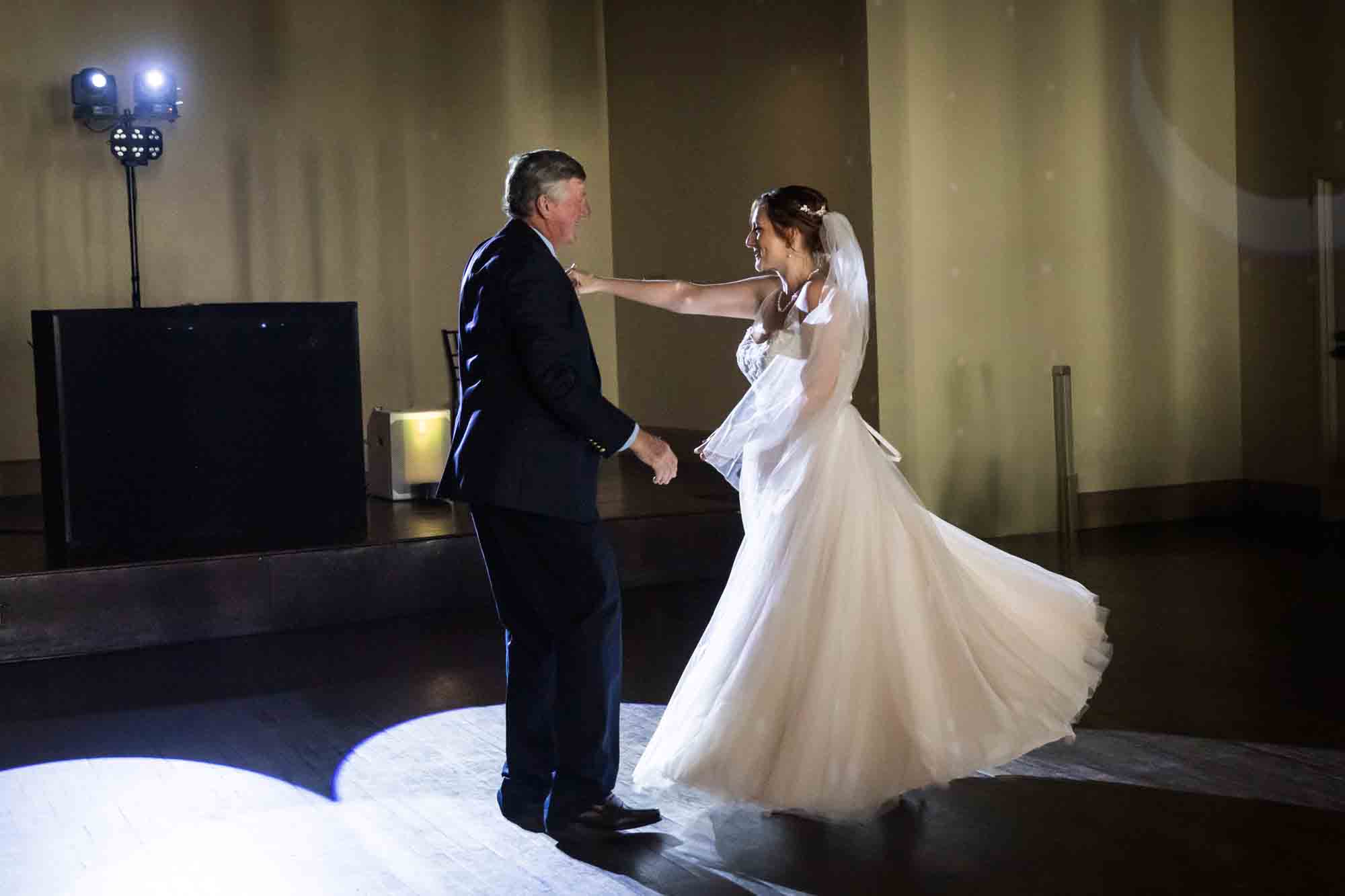 Pat O’Brien wedding photos of bride and father dancing with bride's skirt flaring