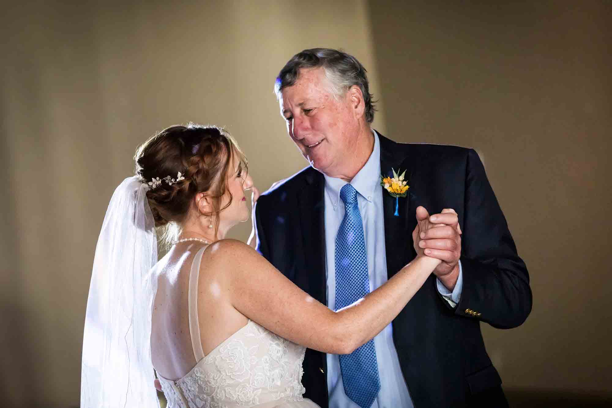 Pat O’Brien wedding photos of bride dancing with father