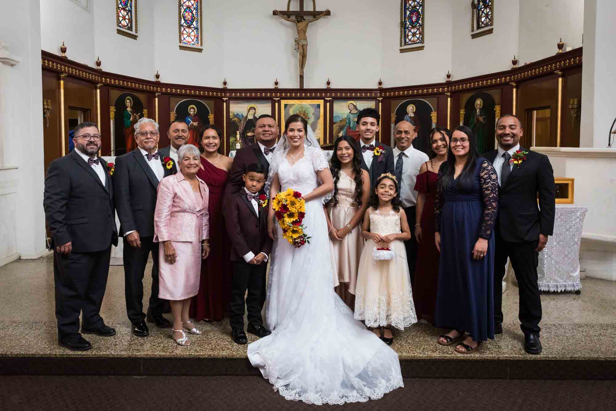 St. Henry Catholic Church wedding photos of bride and groom with family in front of altar