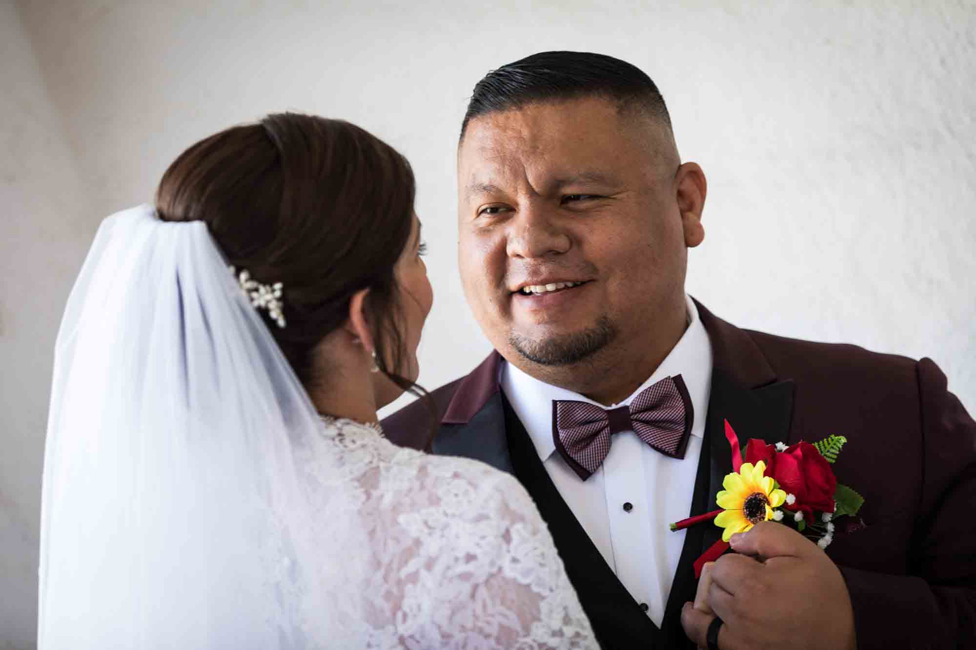 St. Henry Catholic Church wedding photos of bride and groom dancing in front of white wall