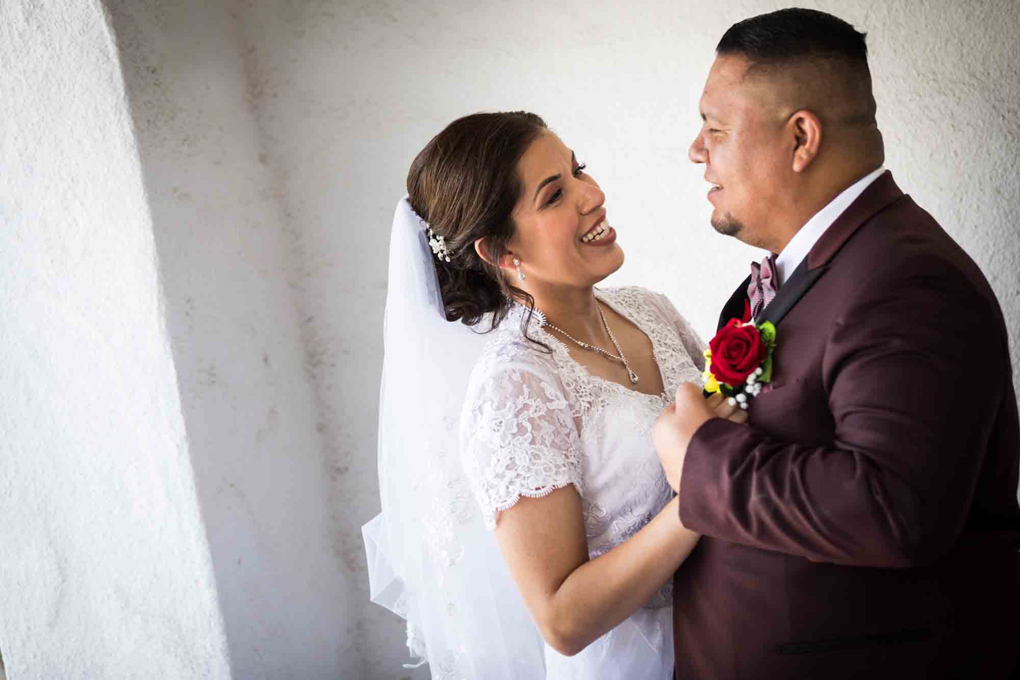 St. Henry Catholic Church wedding photos of bride and groom dancing in front of white wall