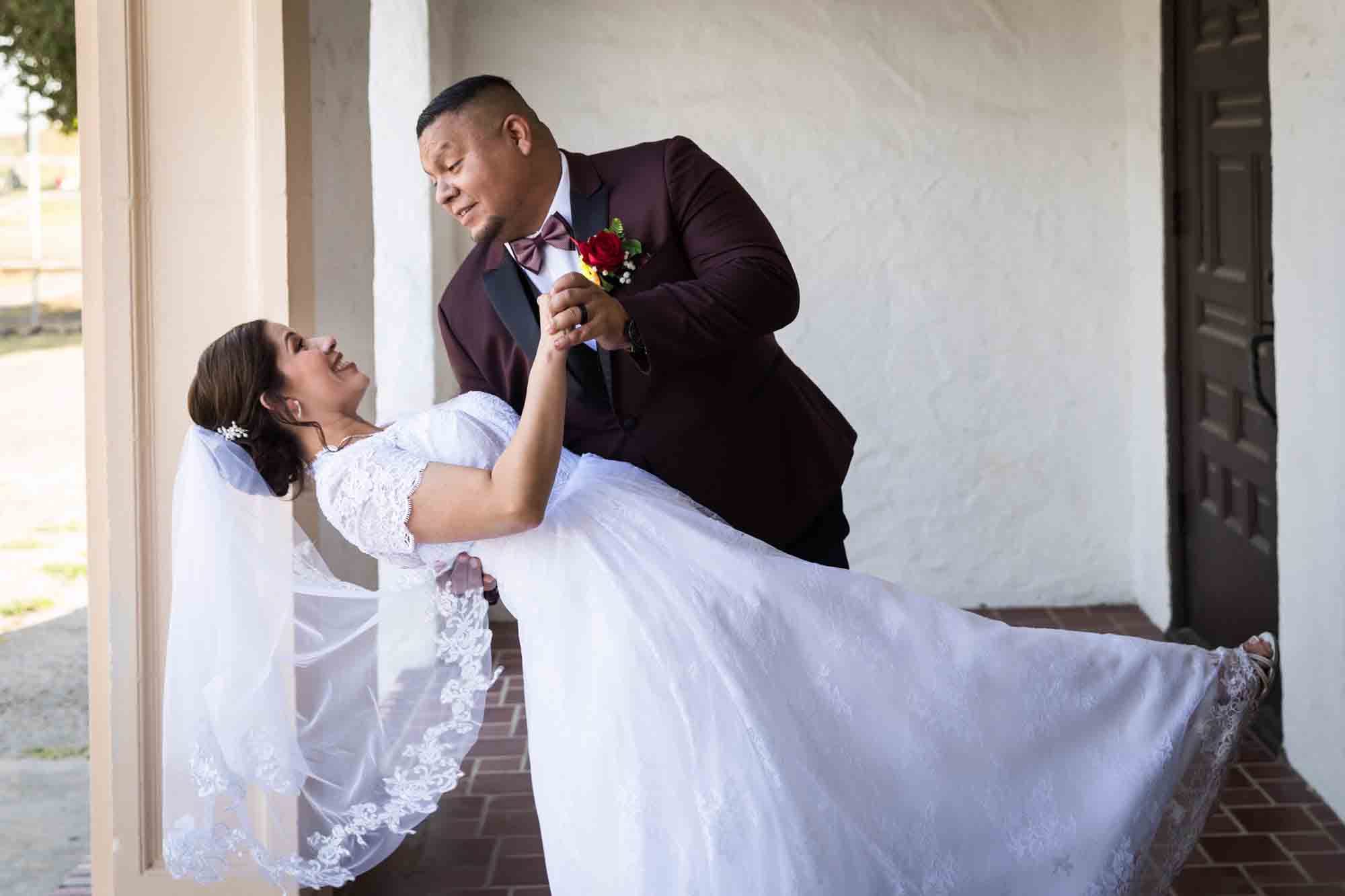 St. Henry Catholic Church wedding photos of groom dipping bride while dancing