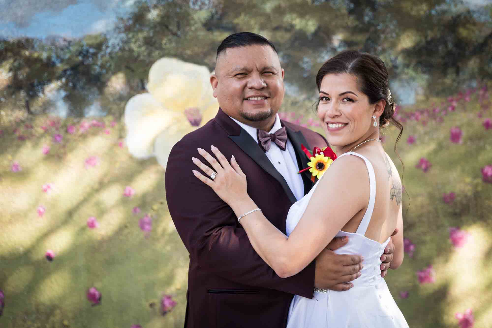 St. Henry Catholic Church wedding photos of bride and groom dancing in front of painting mural of flowers