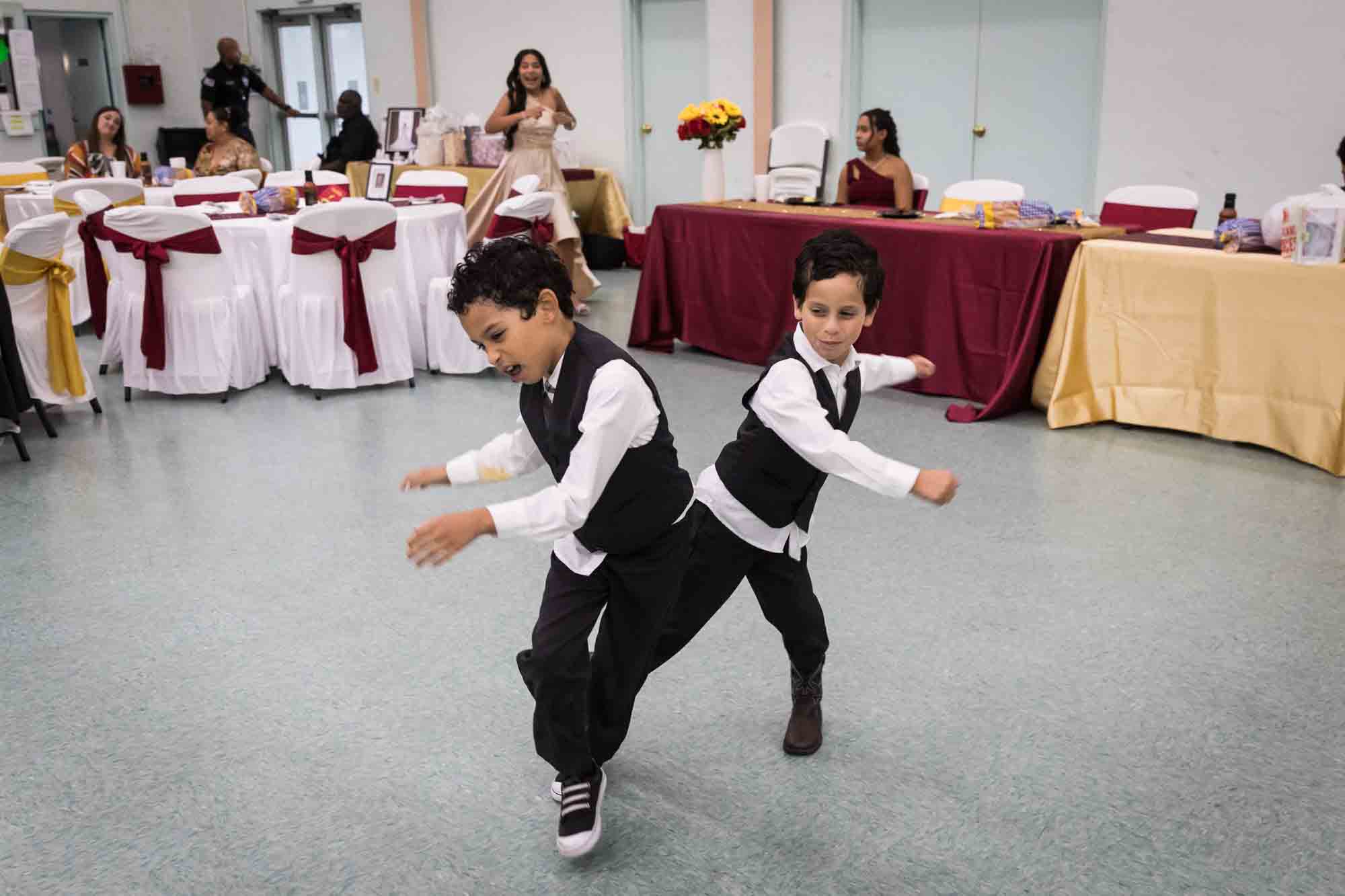 St. Henry Catholic Church wedding photos of two young boys playing at reception