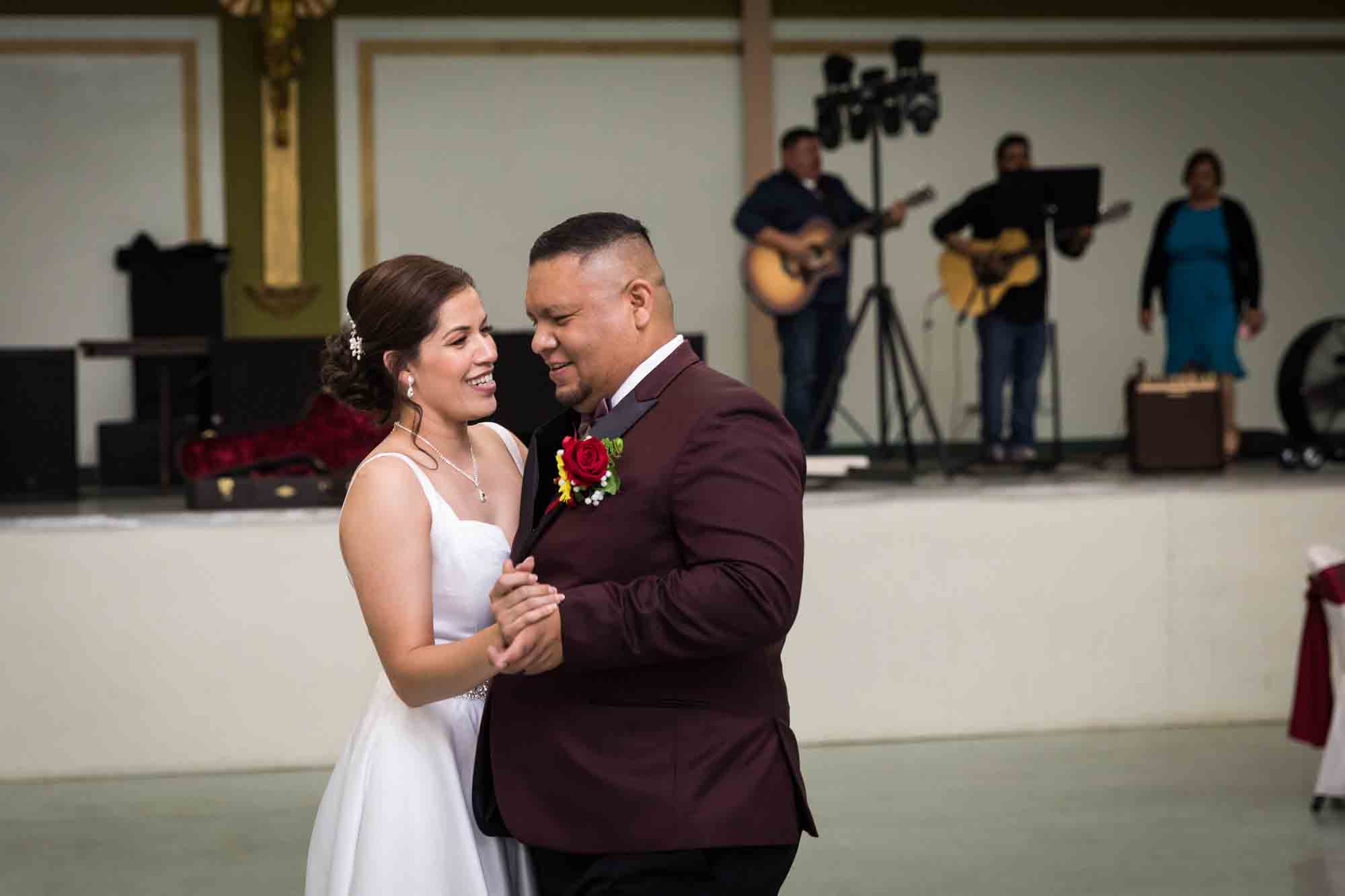 Bride and groom dancing close and looking at each other during a St. Henry Catholic Church wedding reception