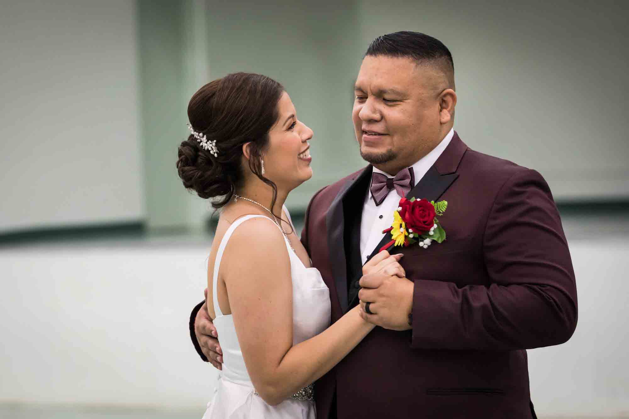 Bride and groom dancing close and looking at each other during a St. Henry Catholic Church wedding reception