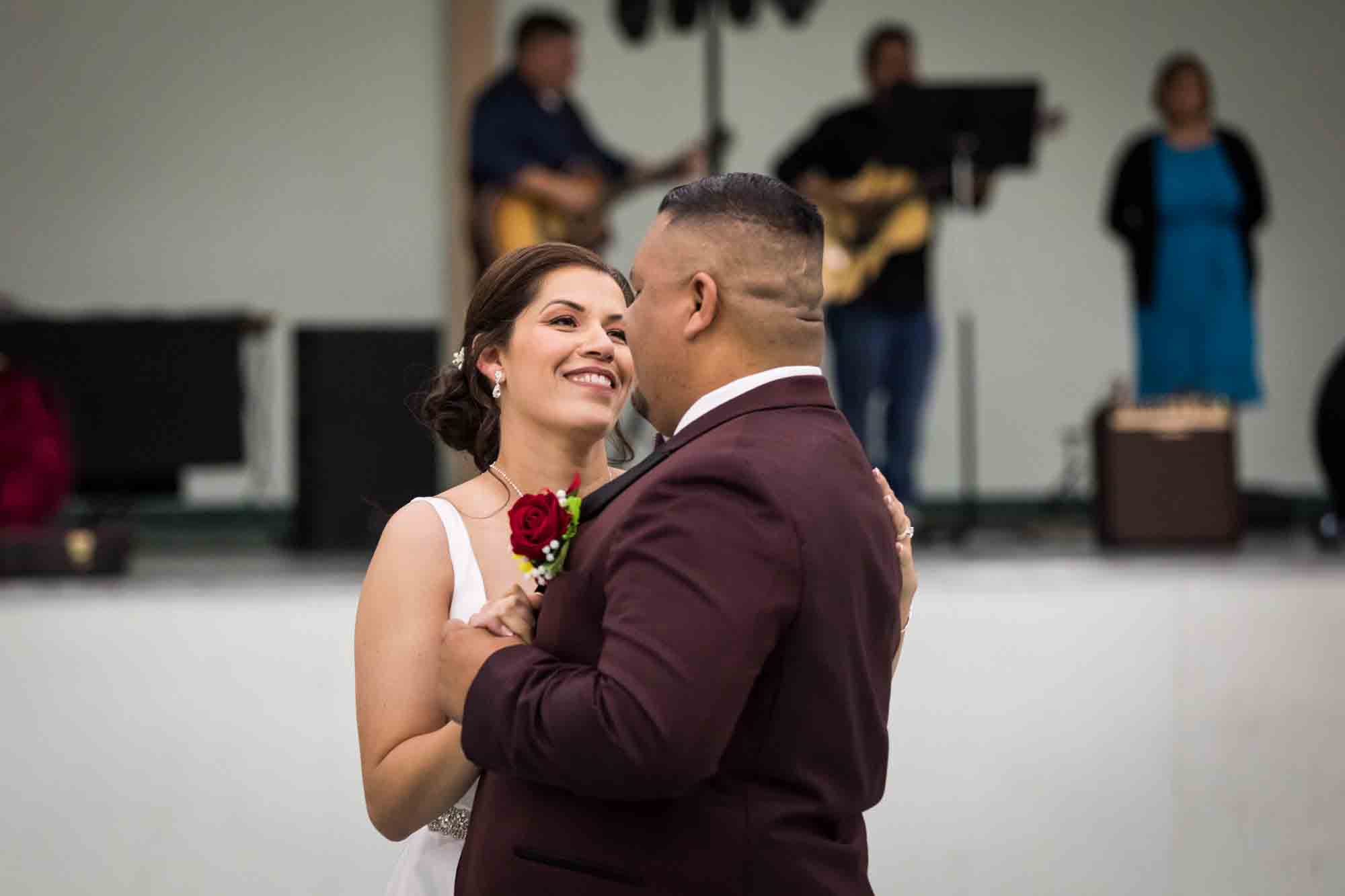 Bride and groom dancing close and looking at each other during a St. Henry Catholic Church wedding reception