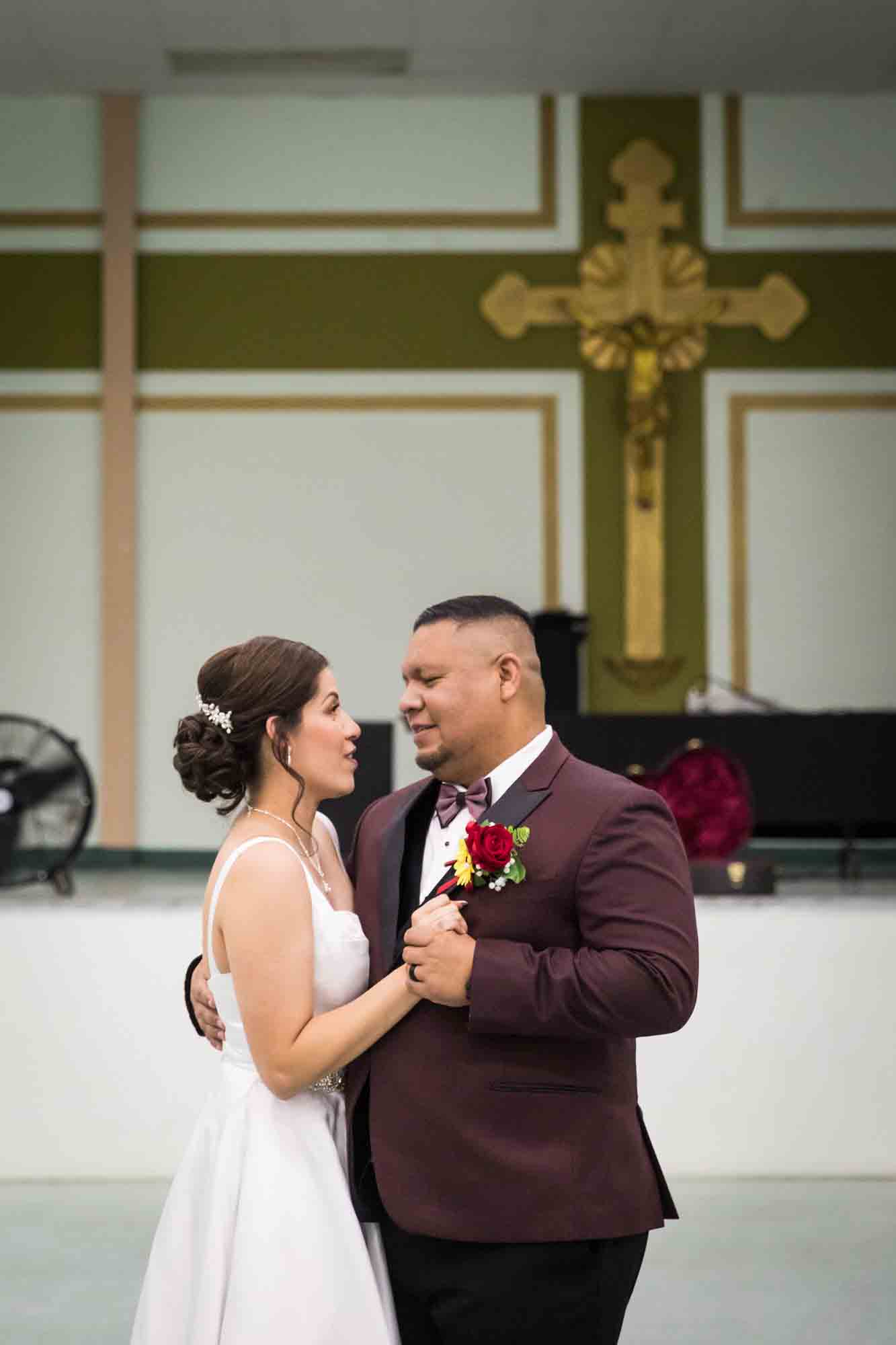 Bride and groom dancing close and looking at each other during a St. Henry Catholic Church wedding reception