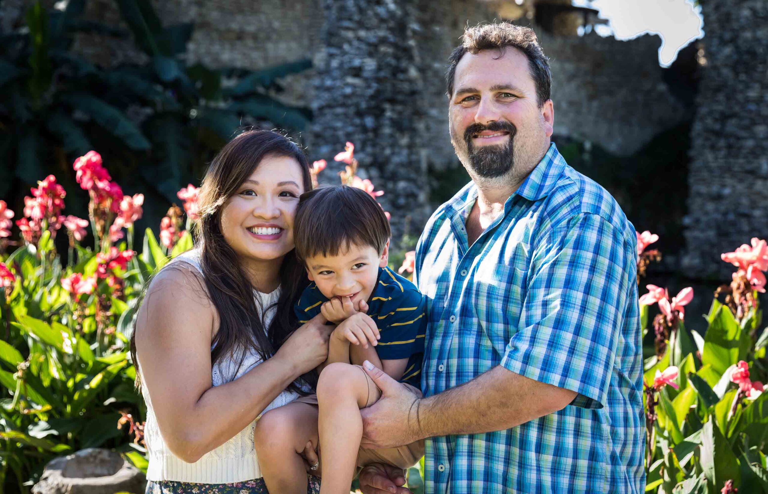 Parents holding little boy in front of plants at the Japanese Tea Garden for an article on photo tips for families with young children