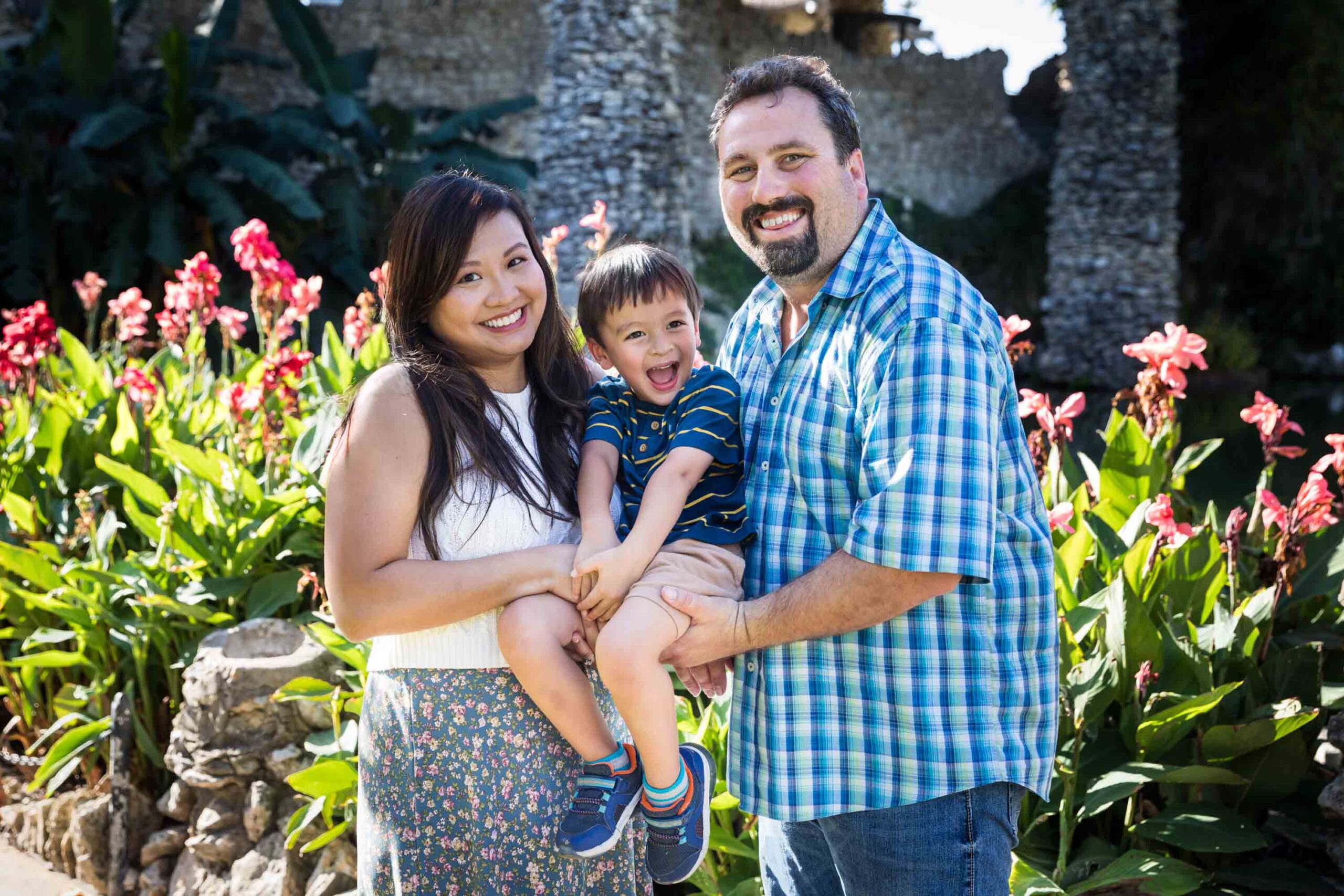 Parents holding little boy in front of plants at the Japanese Tea Garden for an article on photo tips for families with young children