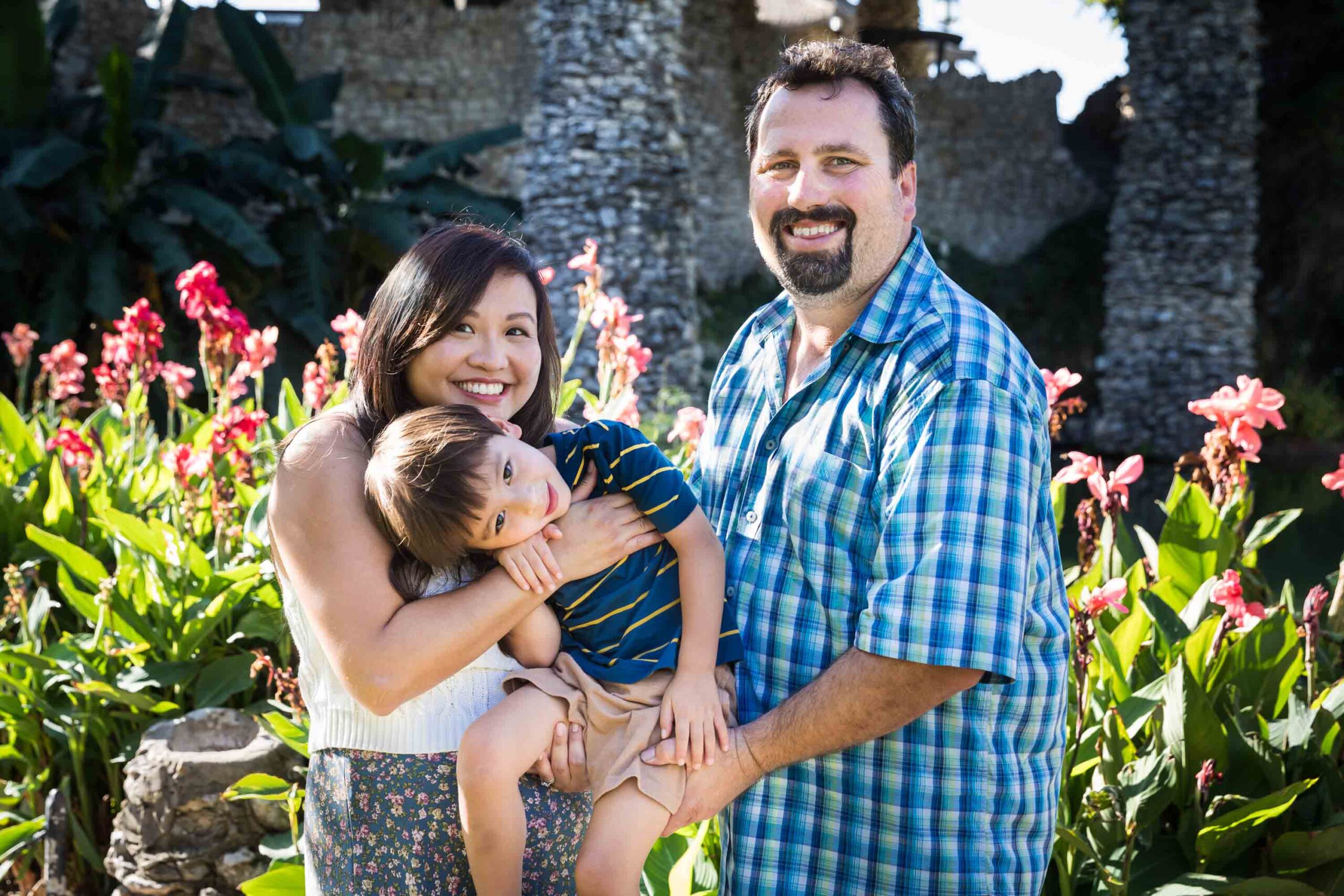 Parents holding little boy in front of plants at the Japanese Tea Garden for an article on photo tips for families with young children