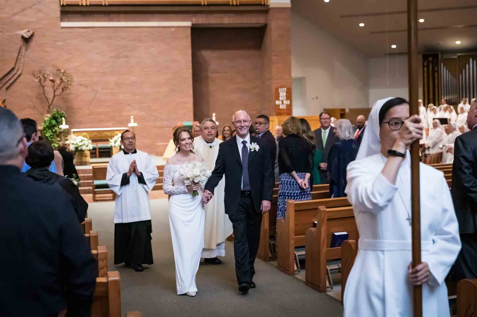 Bride and groom walking down aisle at a St. Mark the Evangelist Catholic Church wedding