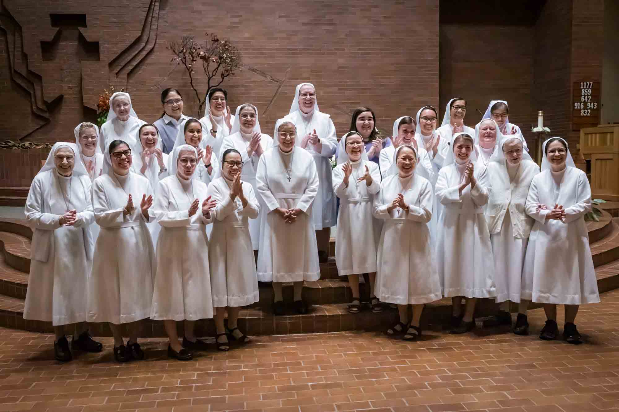 Nuns clapping at a St. Mark the Evangelist Catholic Church wedding