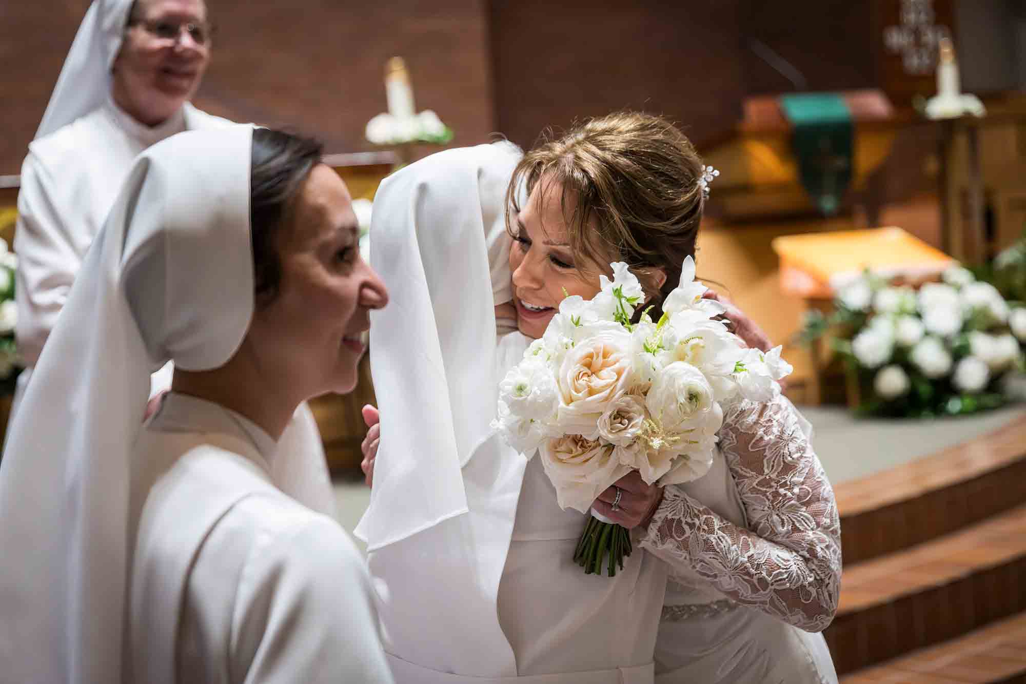 Bride hugging nun at a St. Mark the Evangelist Catholic Church wedding