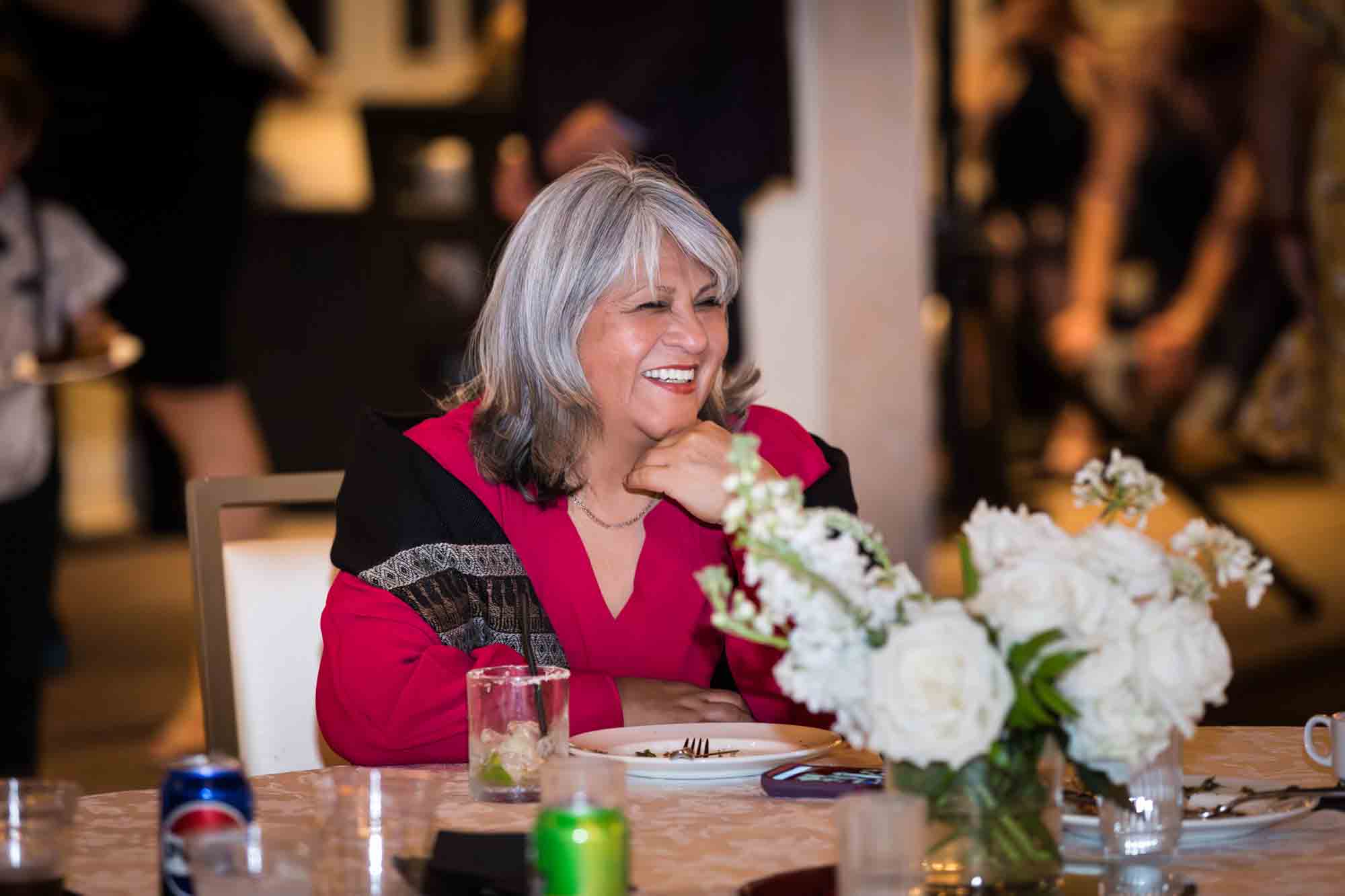 Guests laughing while seated at the Sky Terrace during a St. Anthony Hotel reception