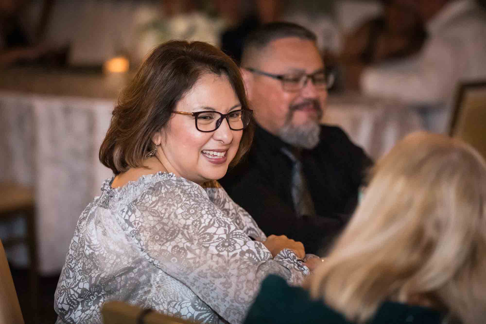 Guests laughing while seated at the Sky Terrace during a St. Anthony Hotel reception