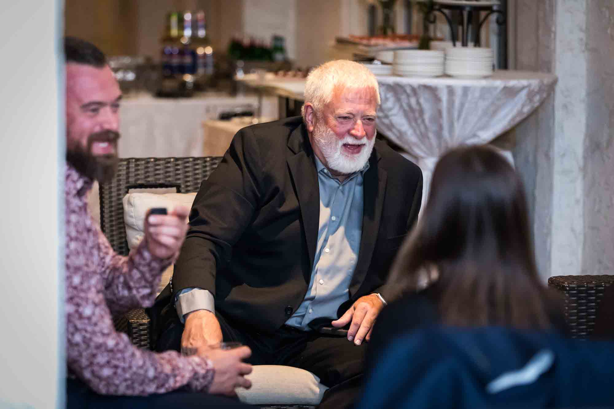 Guests laughing while seated at the Sky Terrace during a St. Anthony Hotel reception