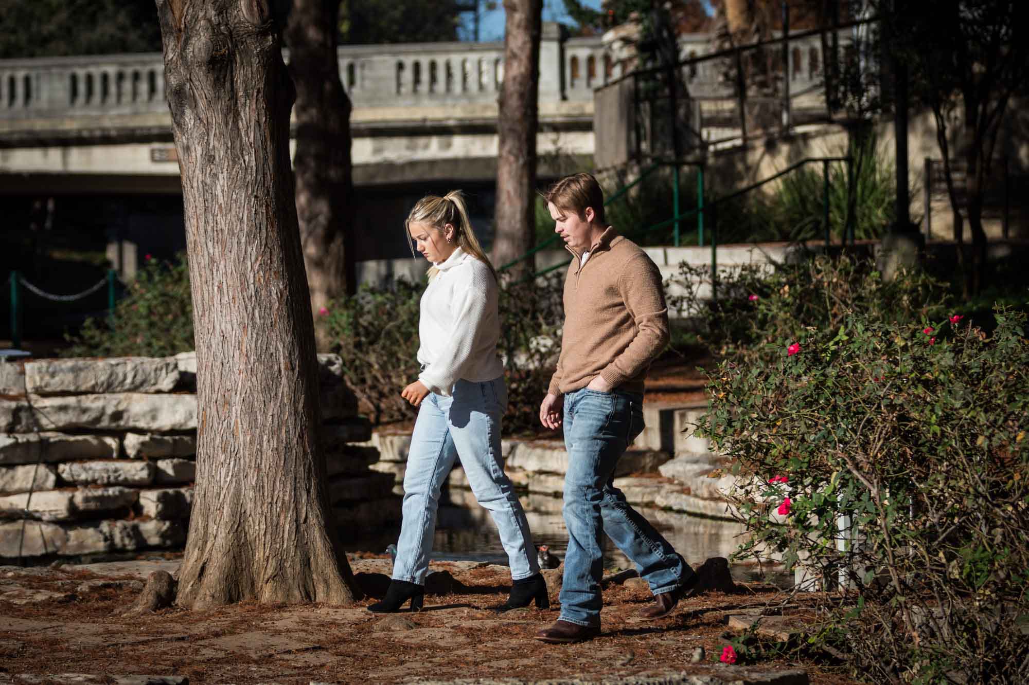 Couple walking in front of tree for an article on the importance of timing for a surprise proposal