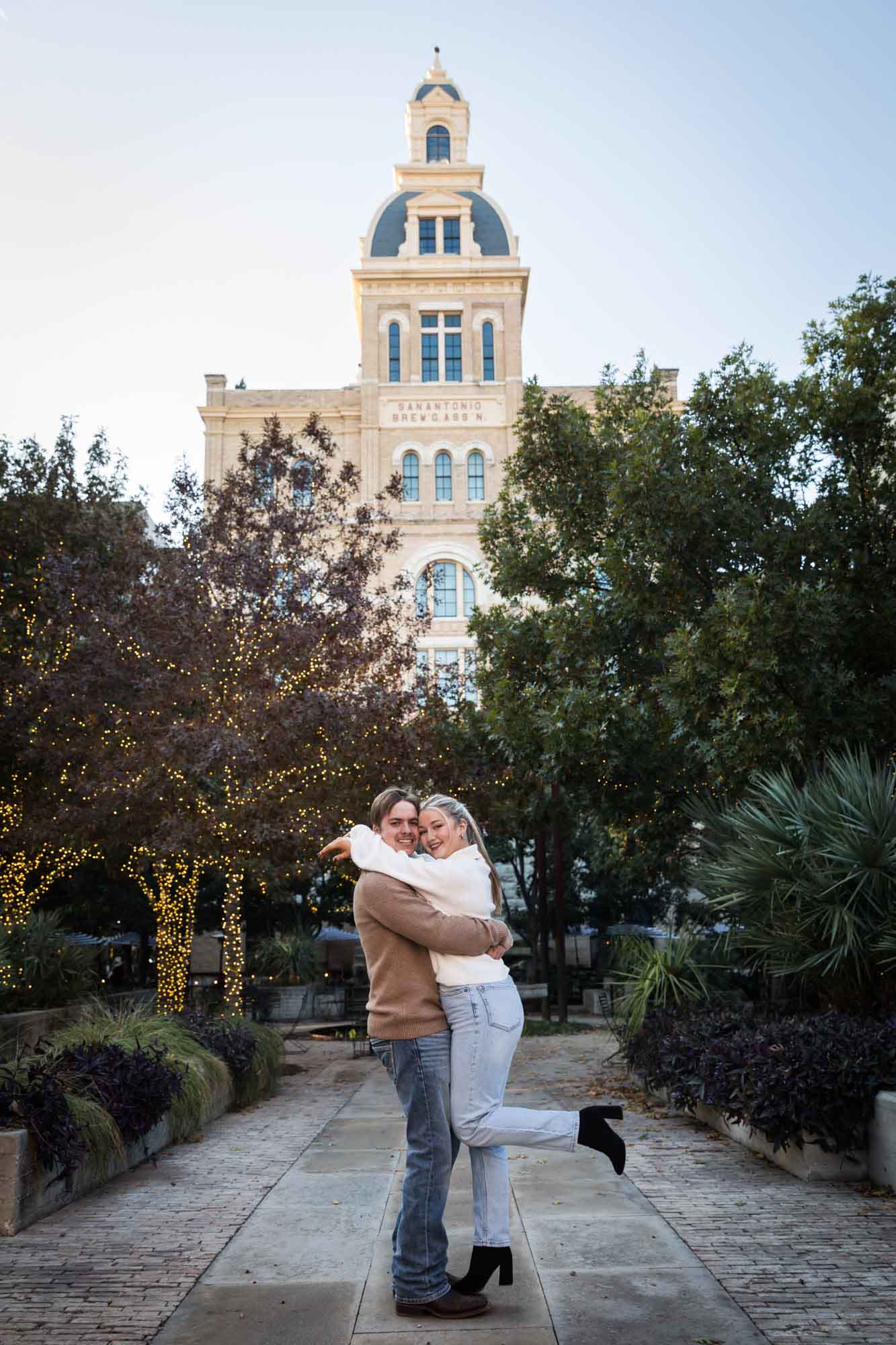 Couple hugging at the historic Pearl for an article on the importance of timing for a surprise proposal