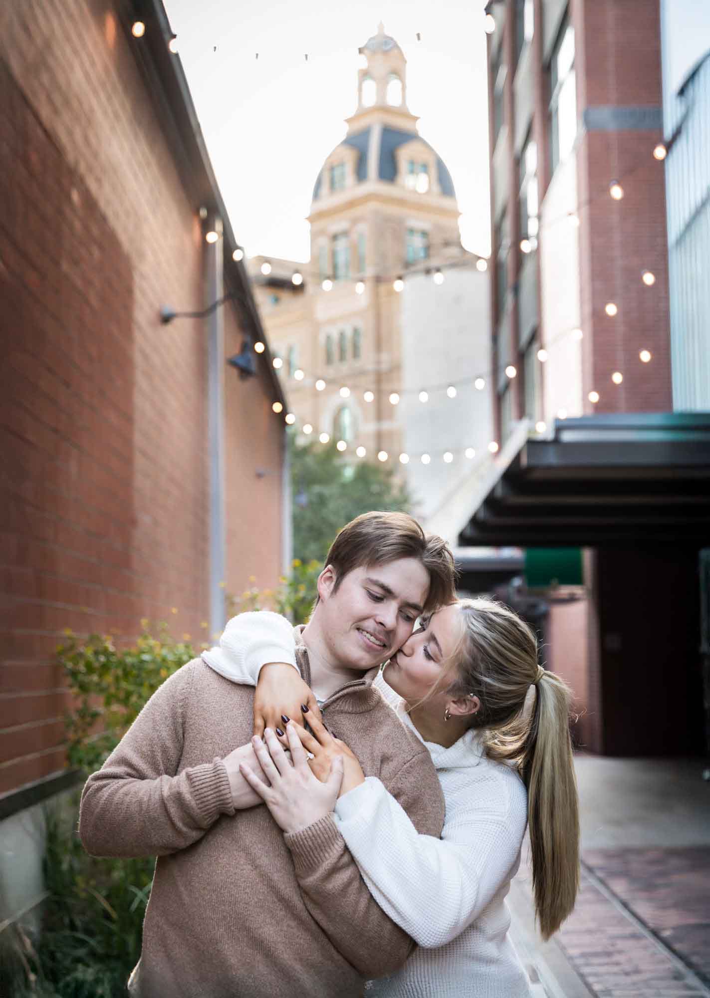 Couple kissing in alleyway at the historic Pearl for an article on the importance of timing for a surprise proposal